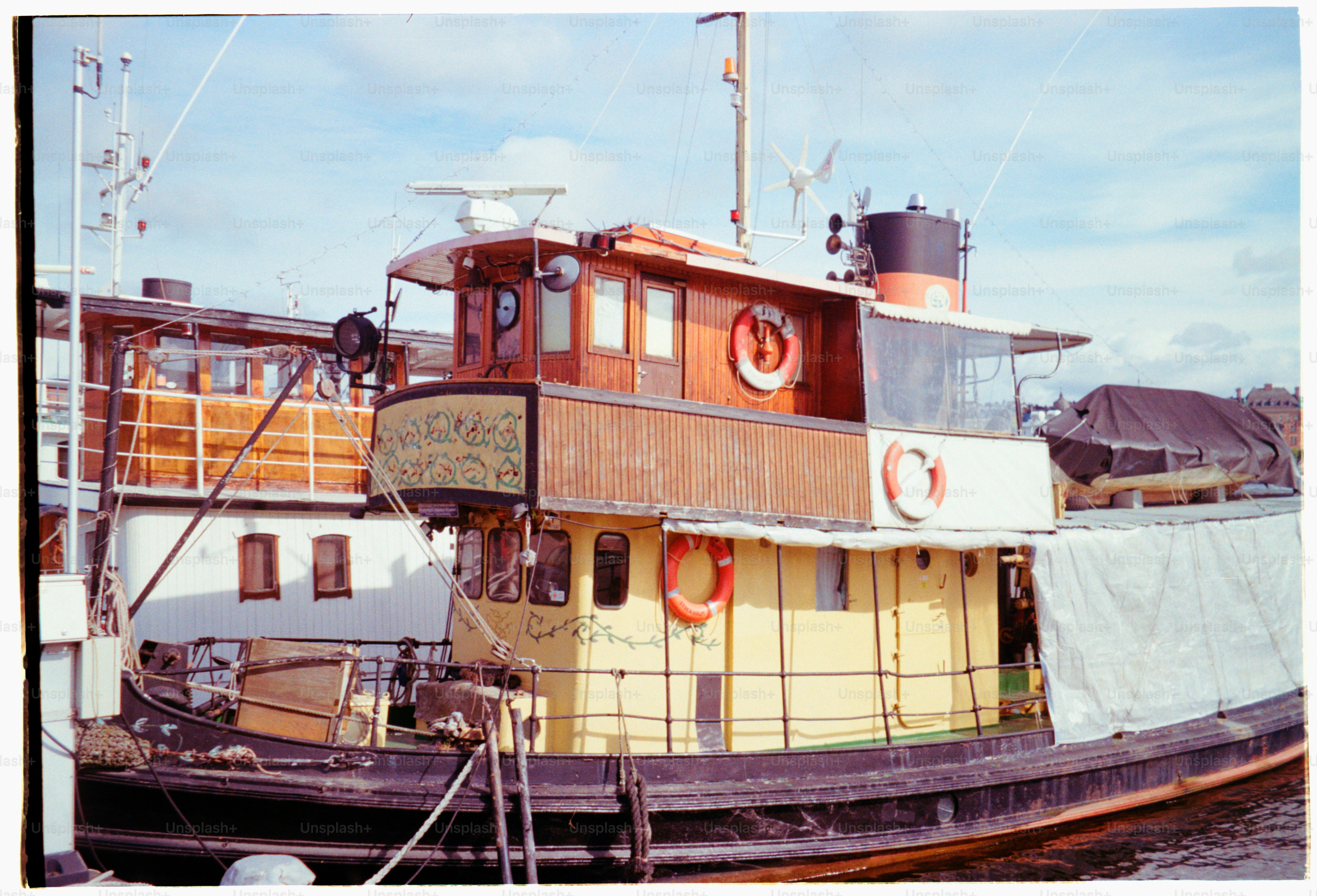 A colorful tugboat rests near a dock.