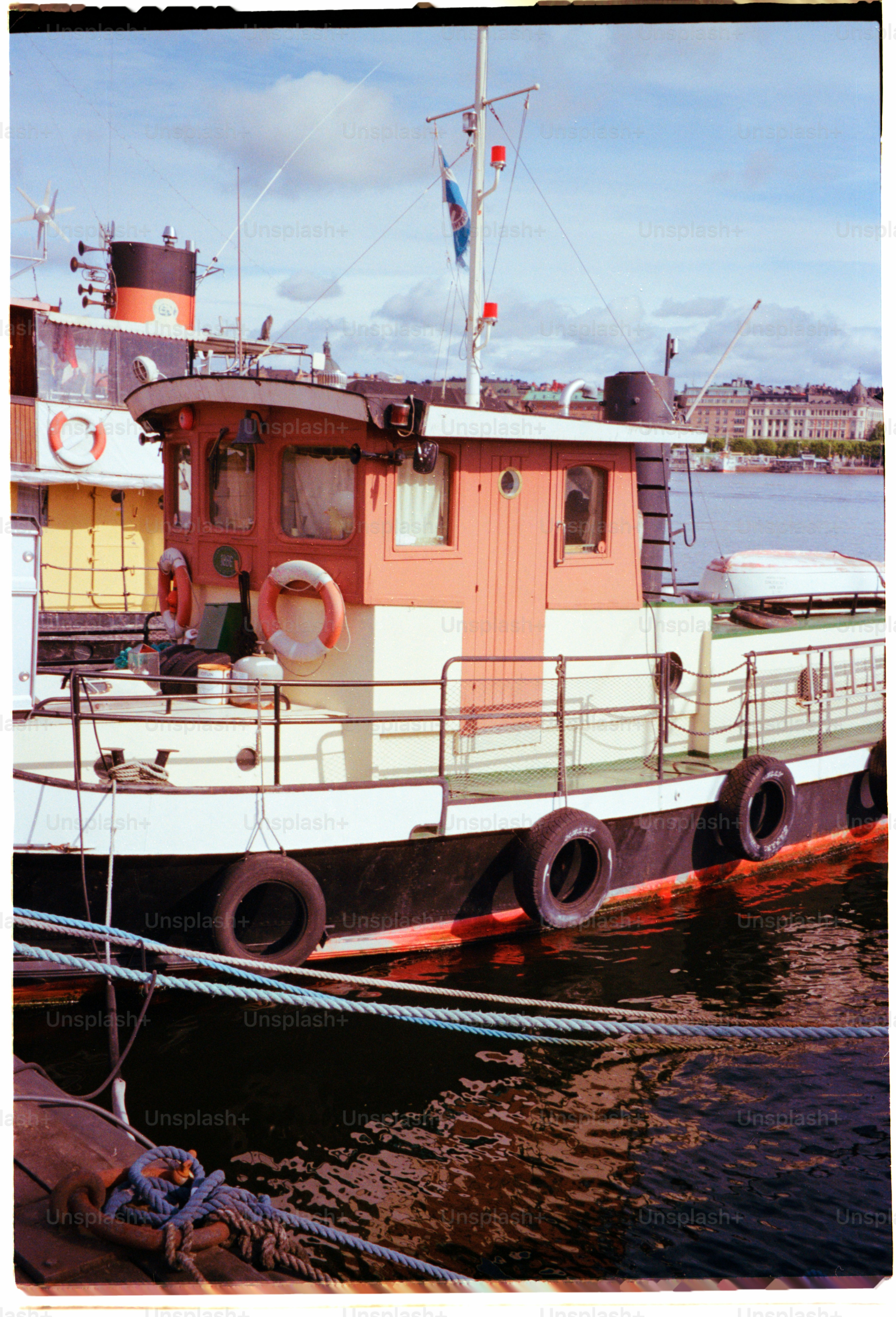 A boat is docked next to another vessel.