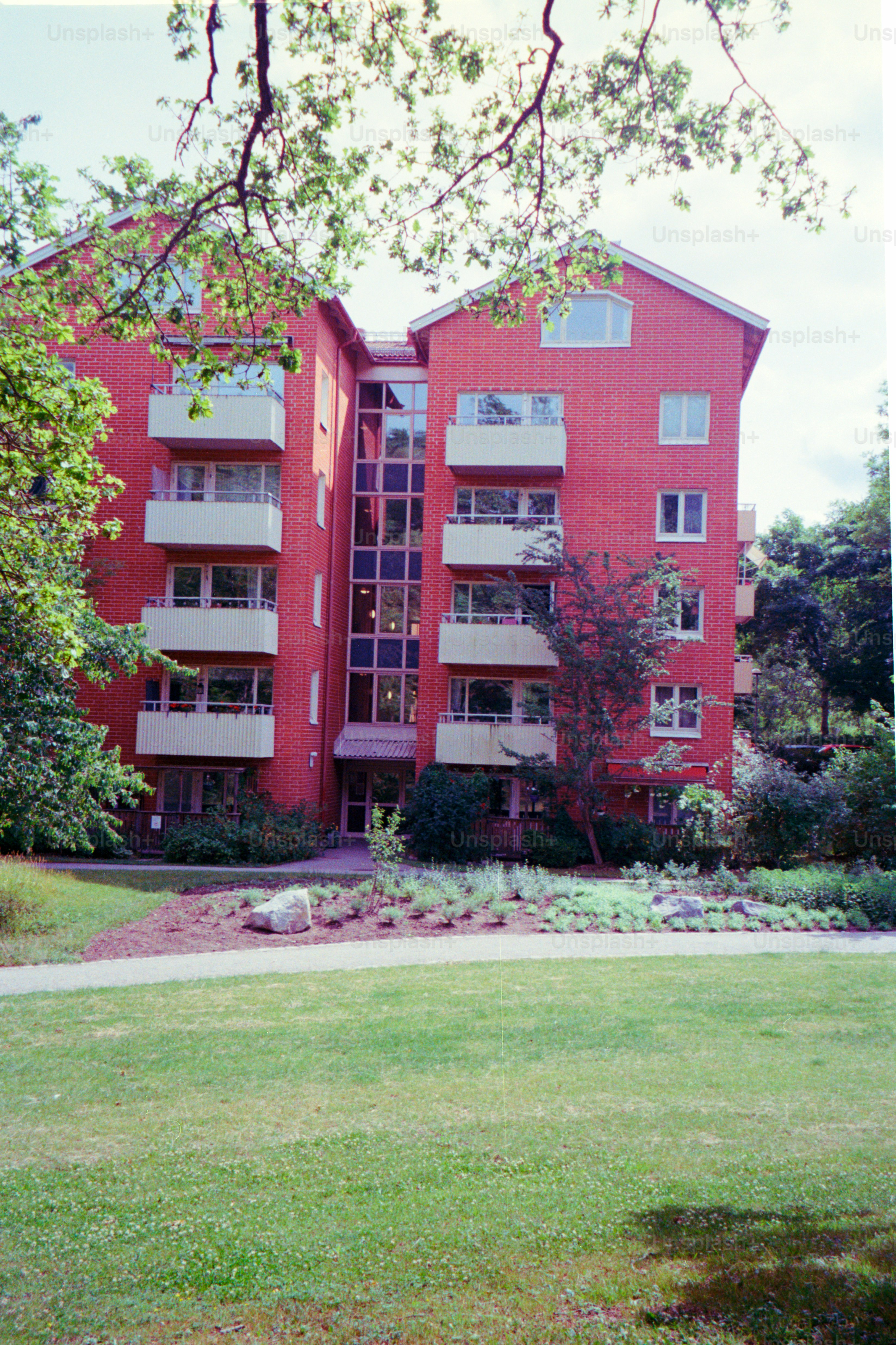 Red brick apartment building with balconies.