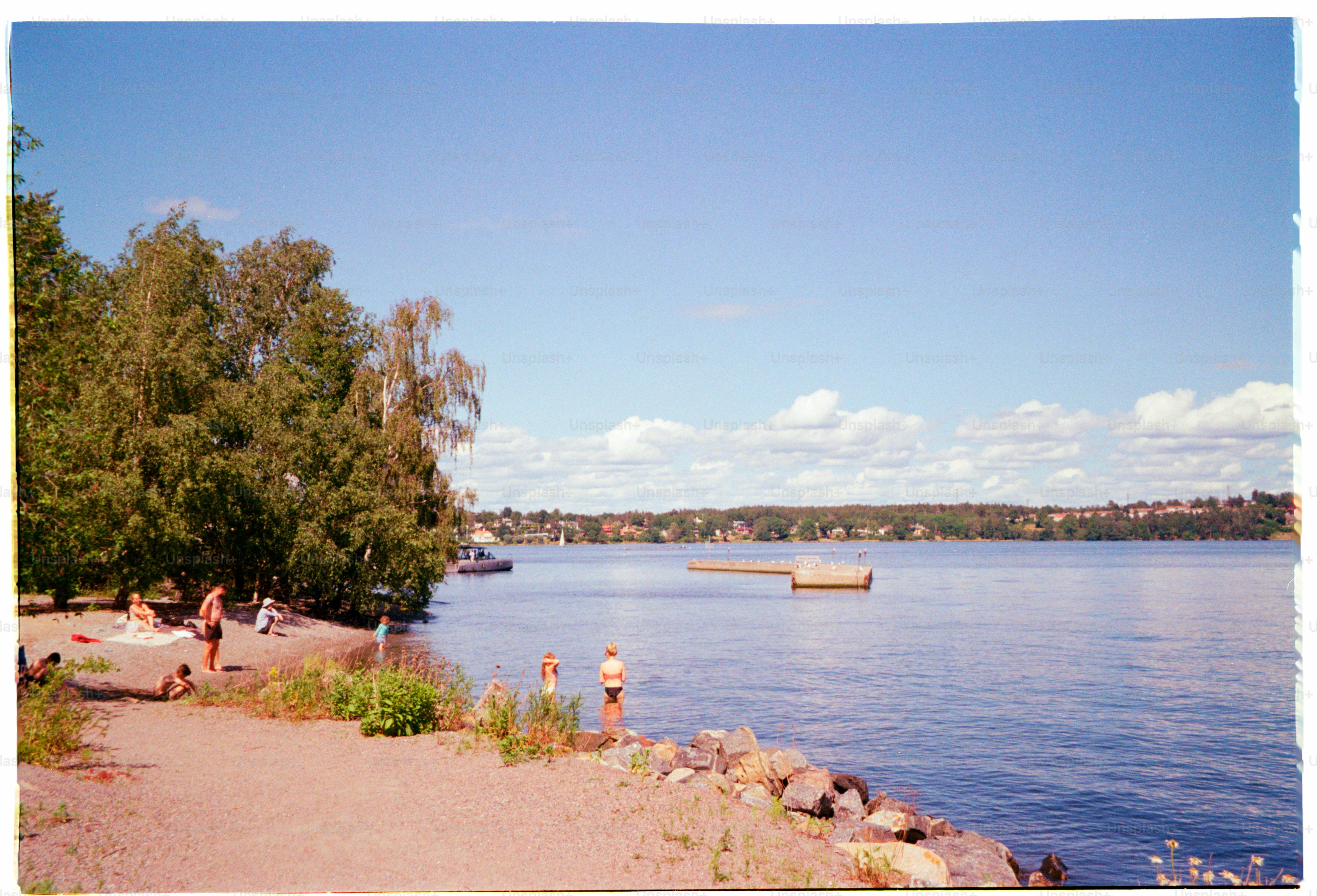 People are enjoying a sunny day by the lake.