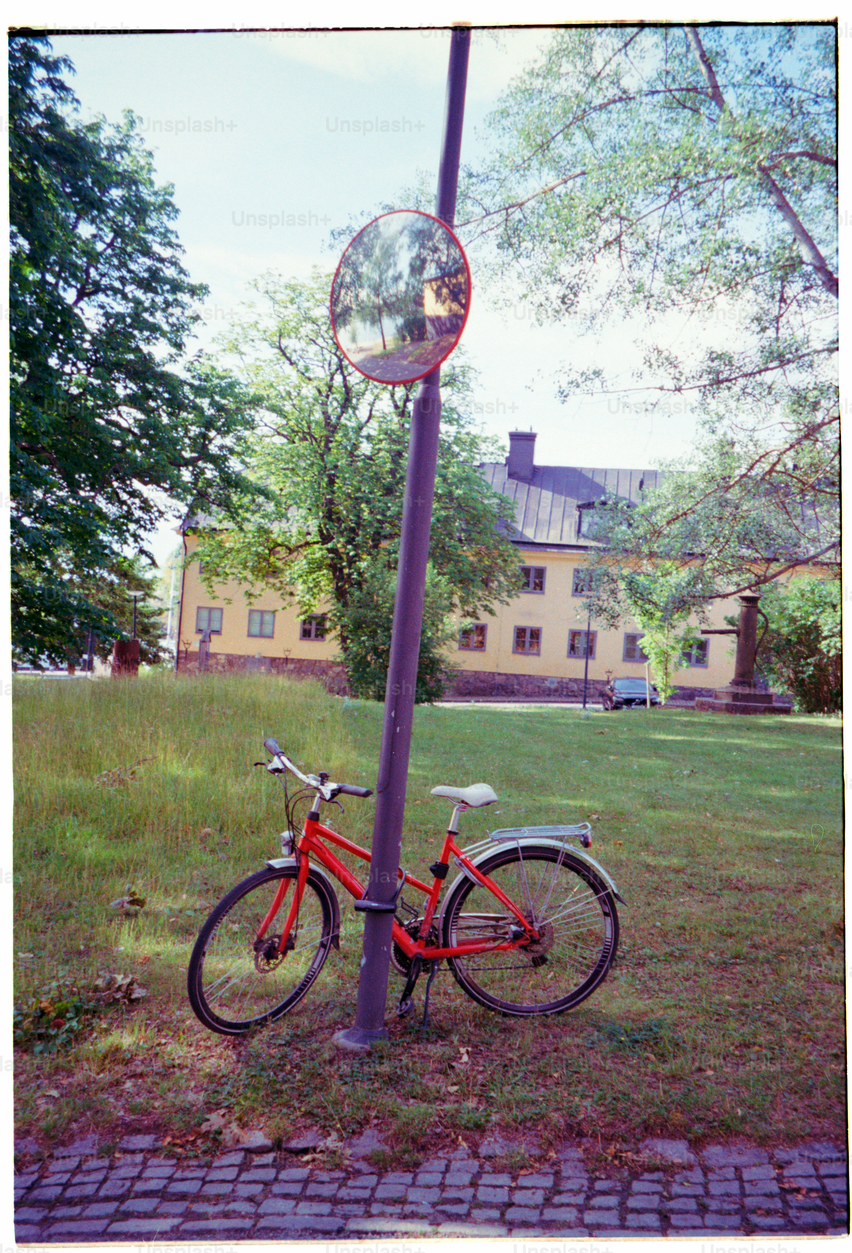 A red bicycle rests near a mirror.