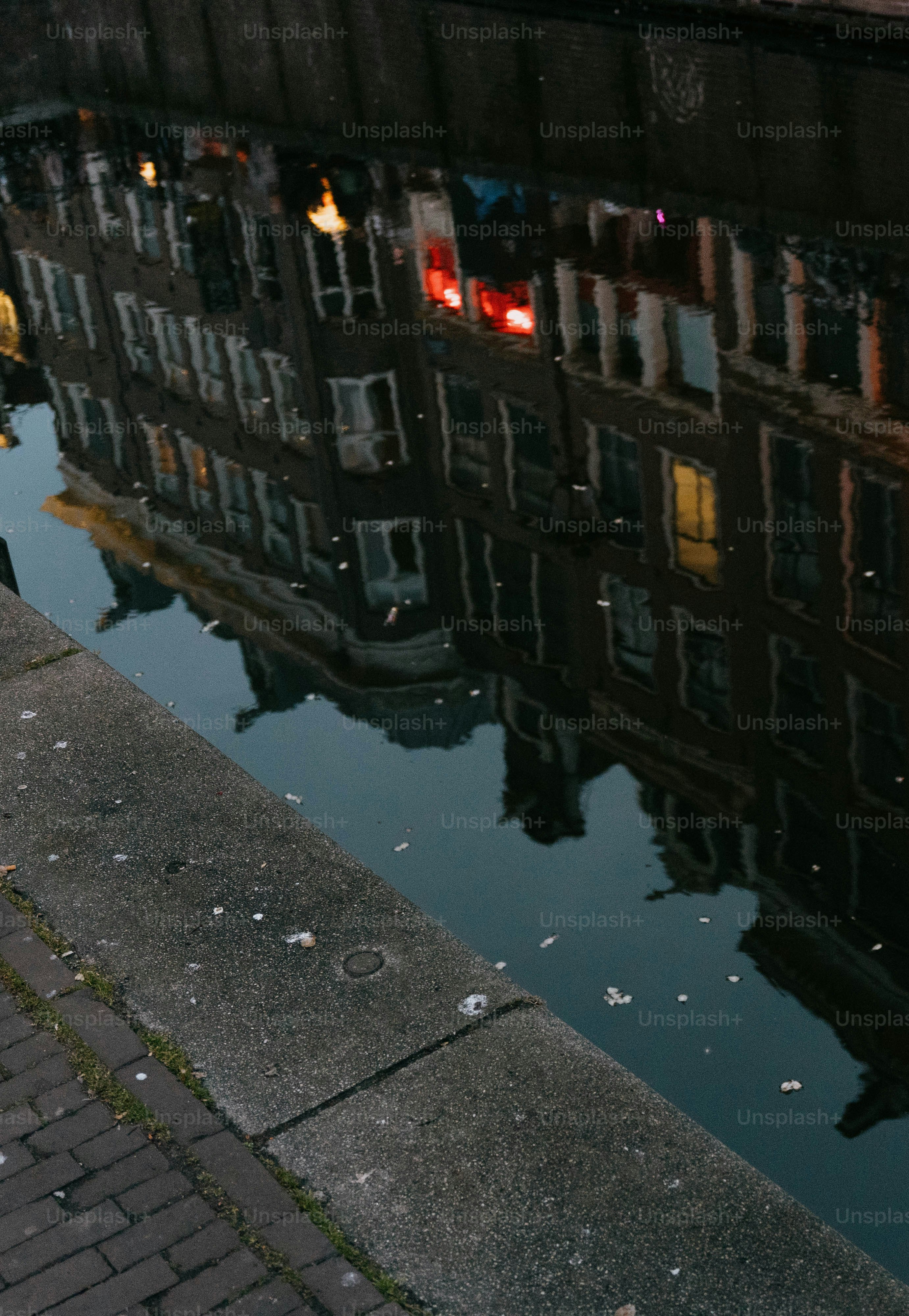 Buildings reflected in calm canal water.