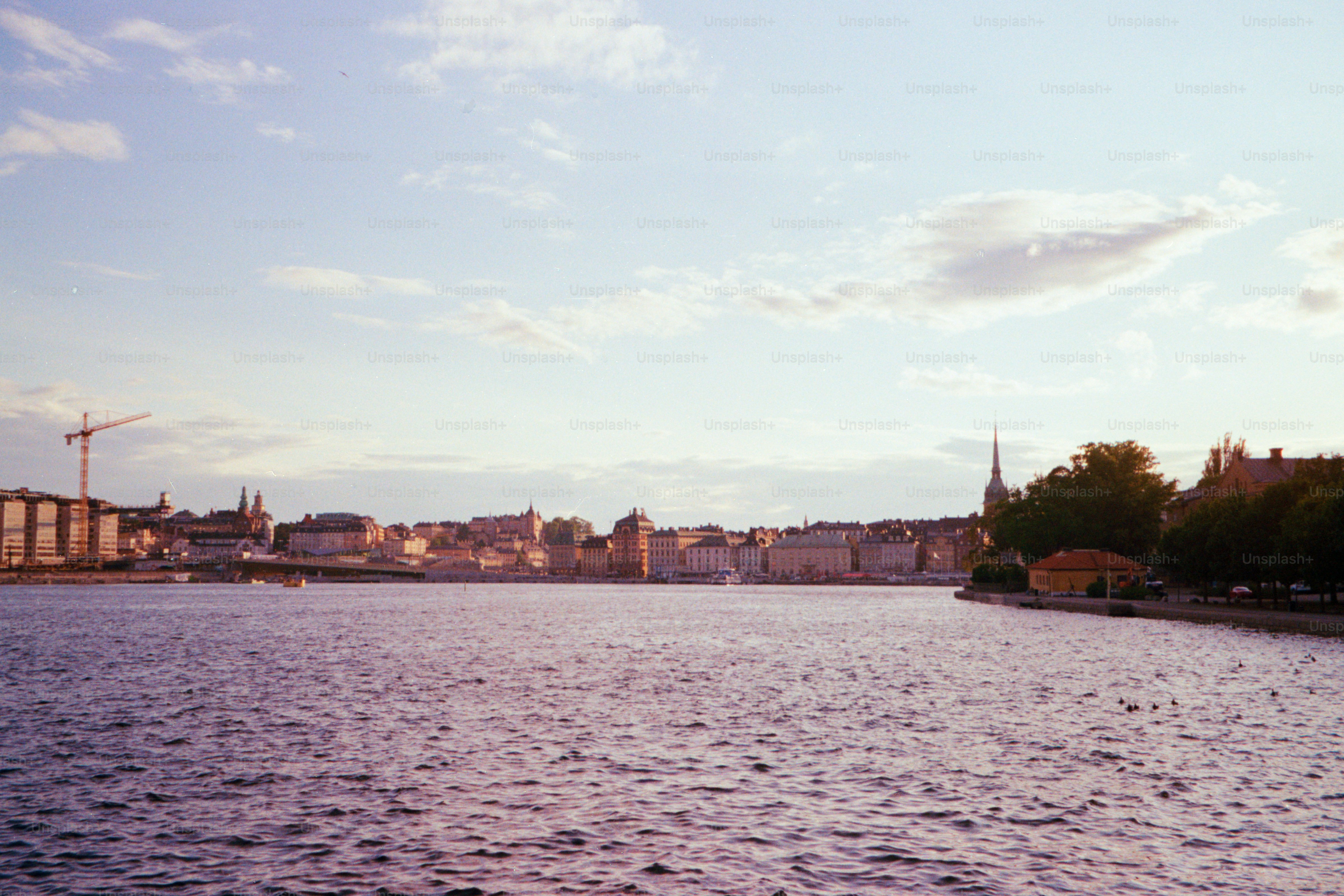Cityscape reflecting in calm, rippling water.