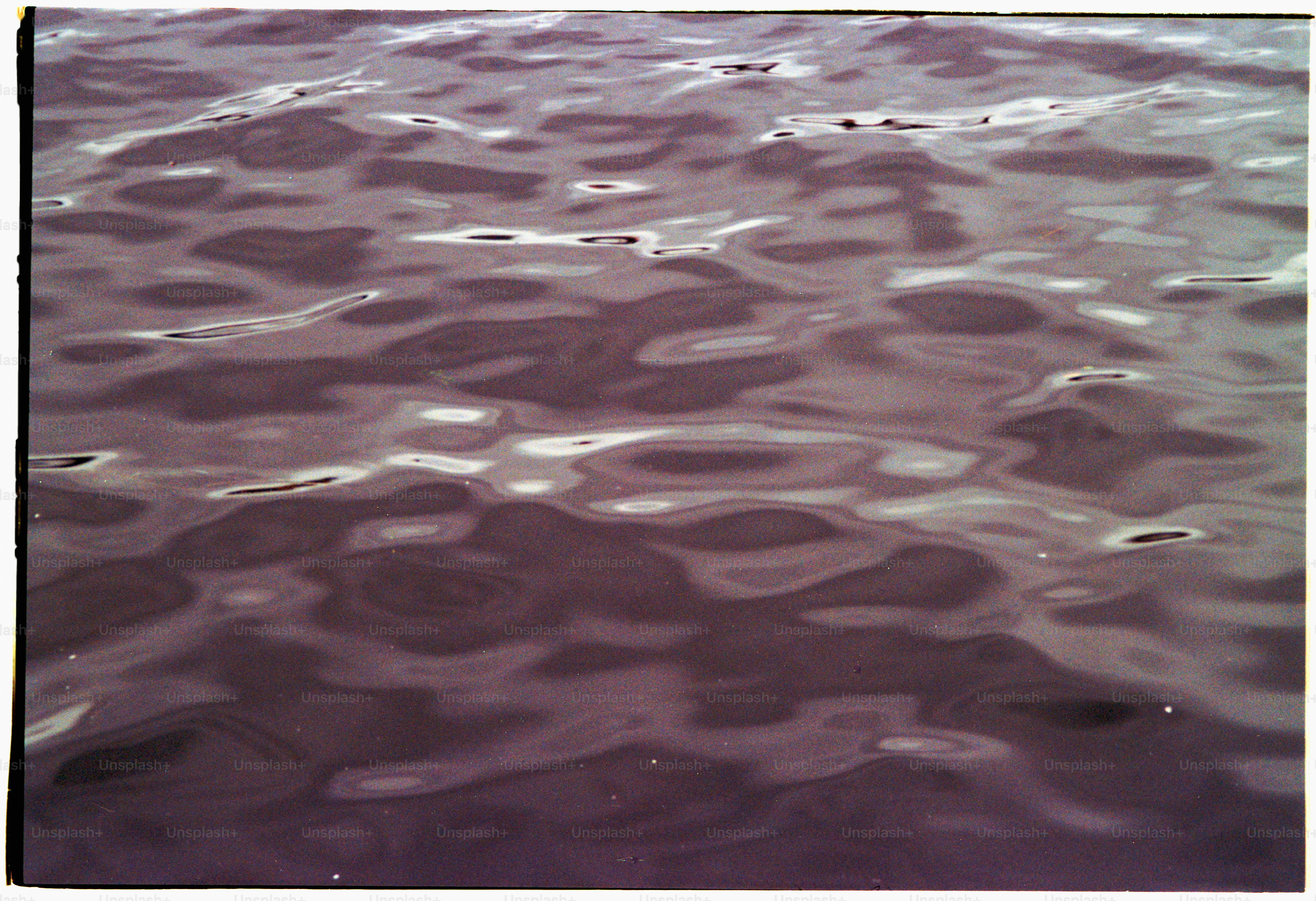 Water's surface with gentle ripples and reflections.