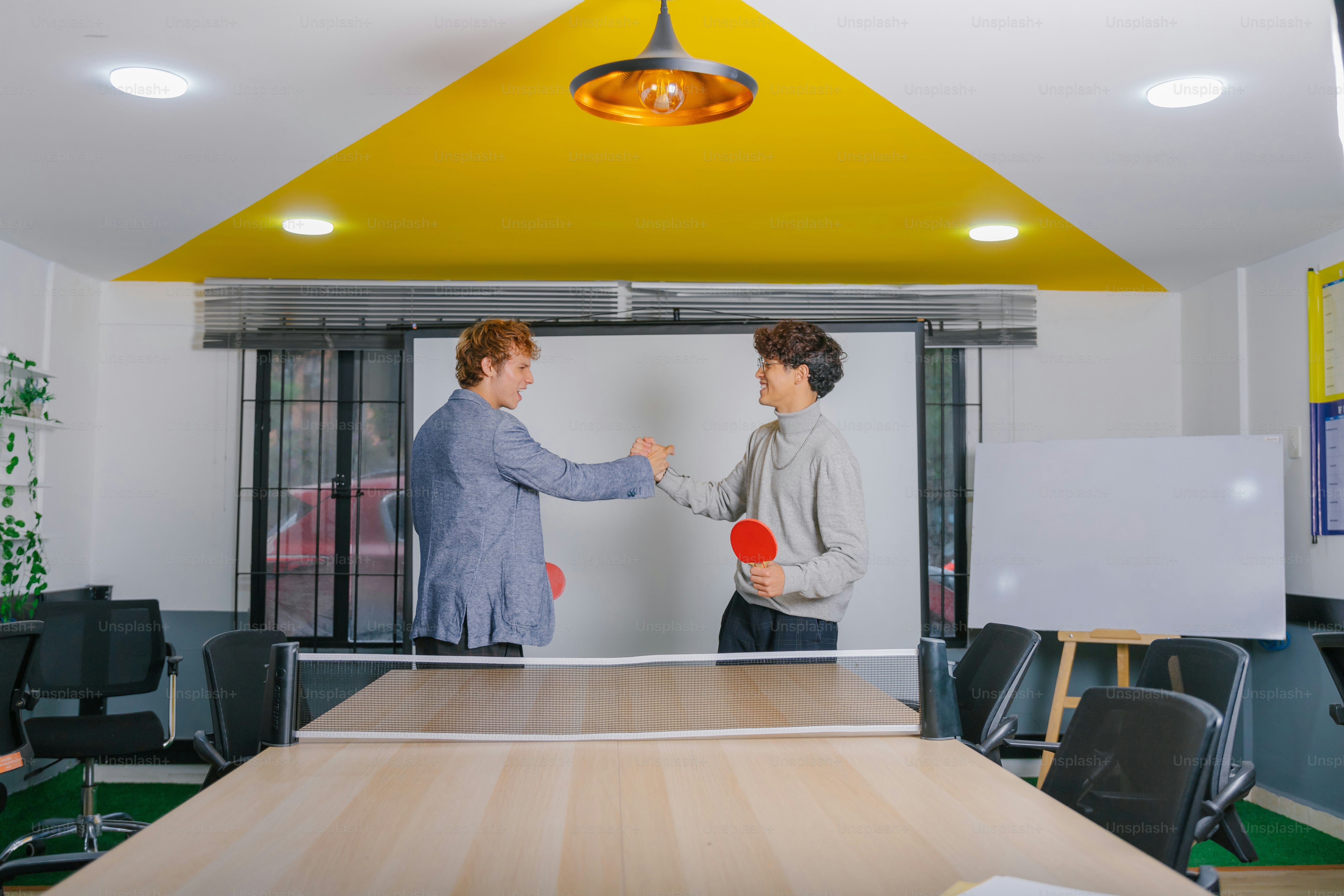 Two people celebrate after a table tennis match.
