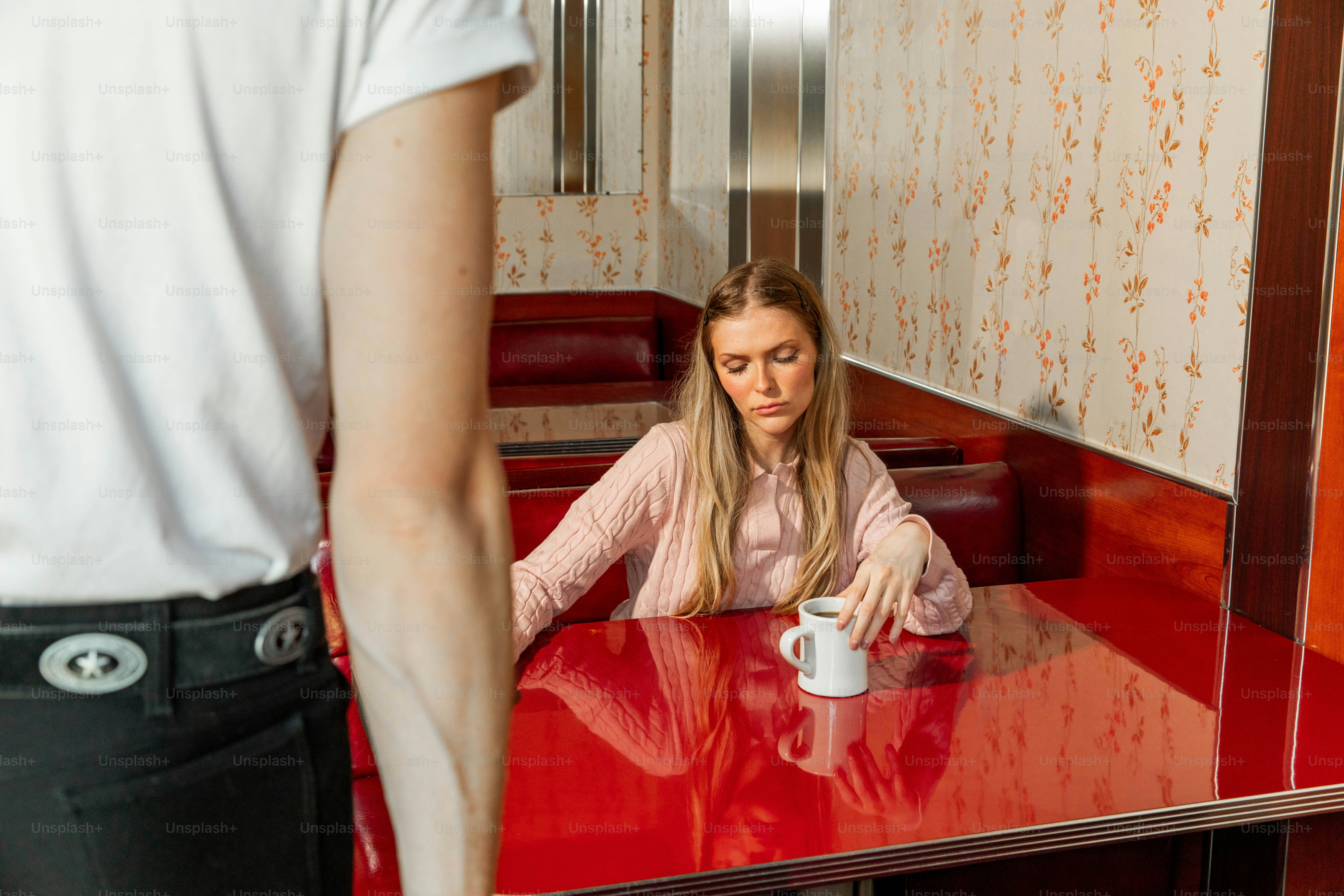 Une serveuse sert du café à une femme dans un restaurant