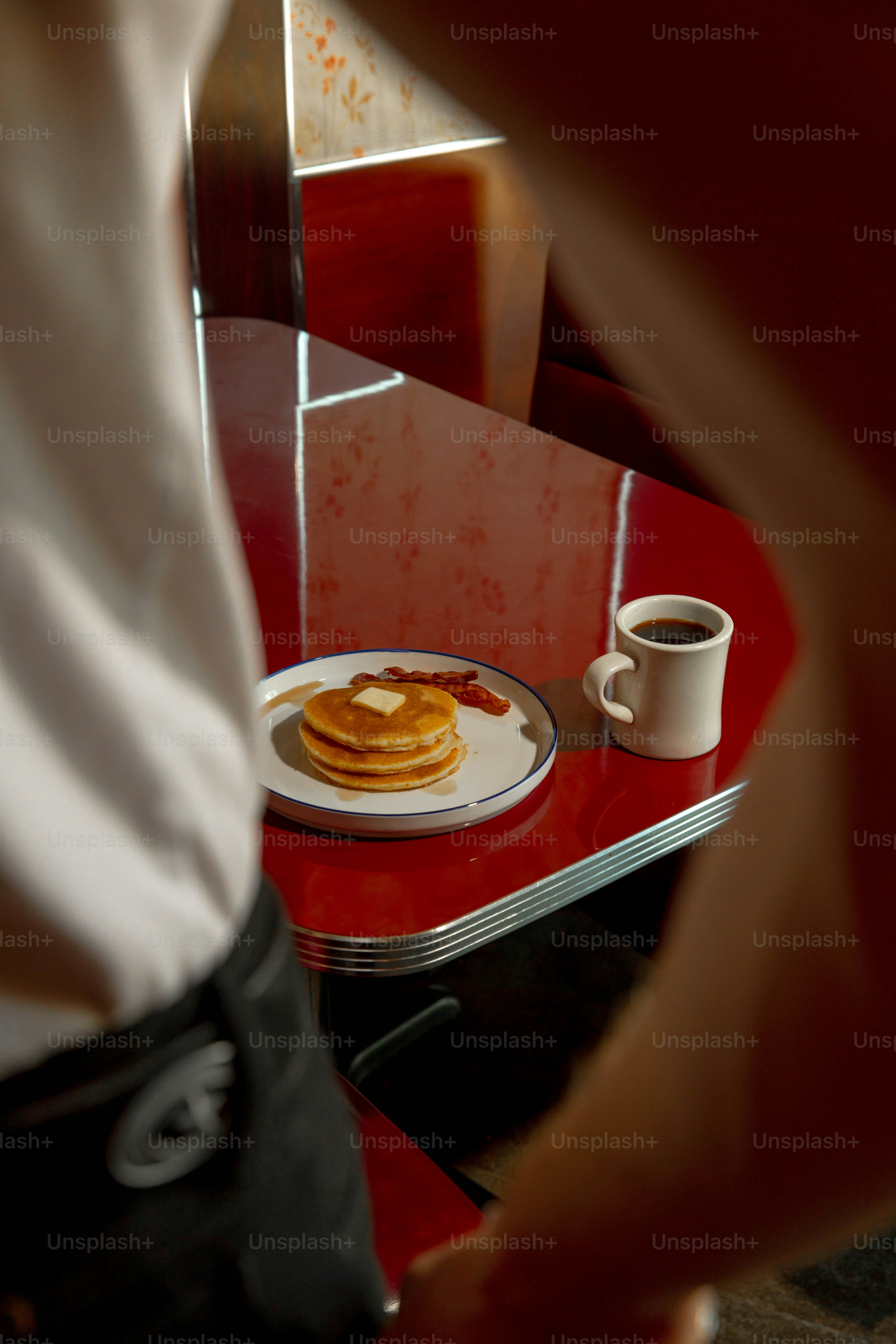 Pancakes and coffee on a diner table.