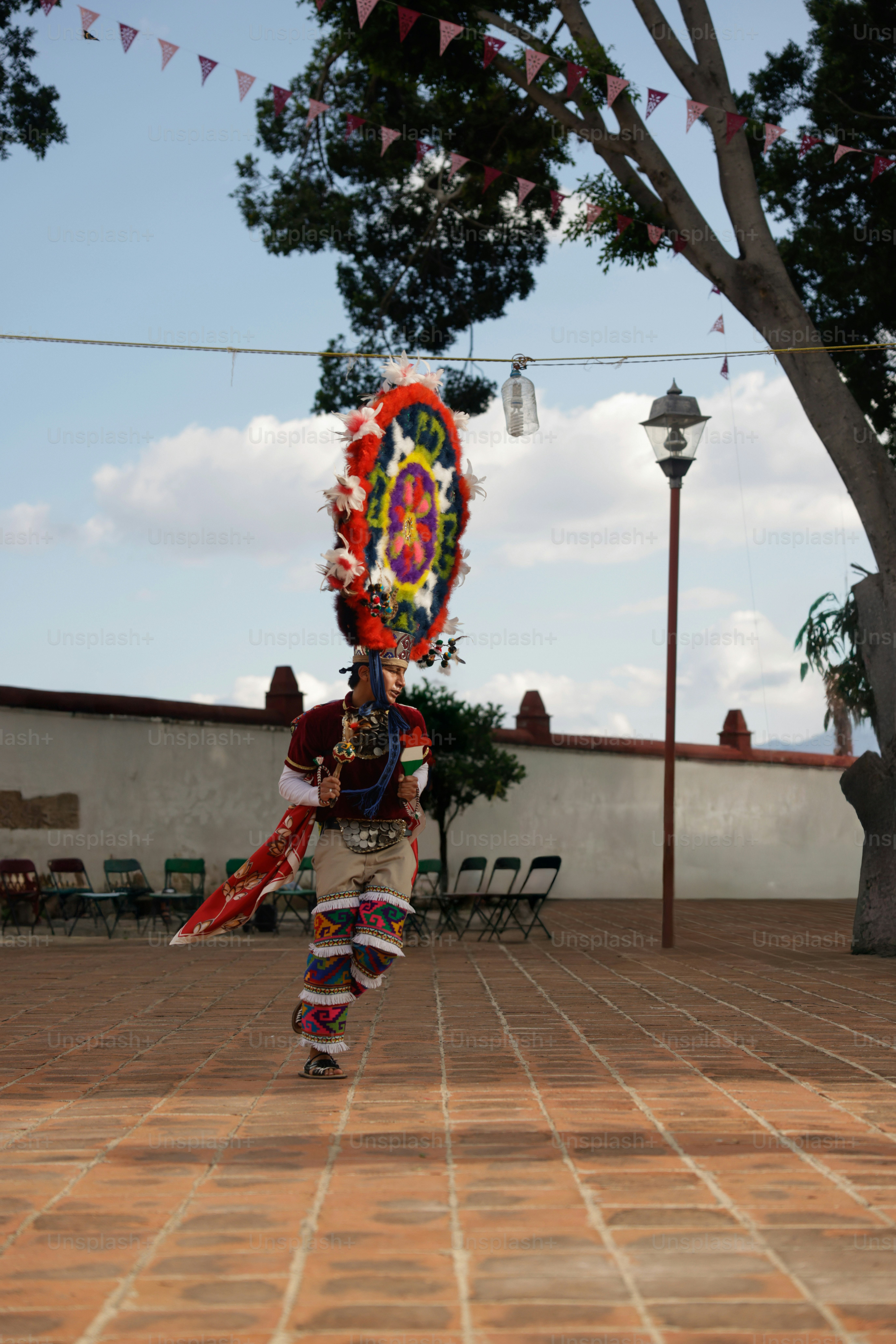 A dancer performs in traditional attire outdoors.