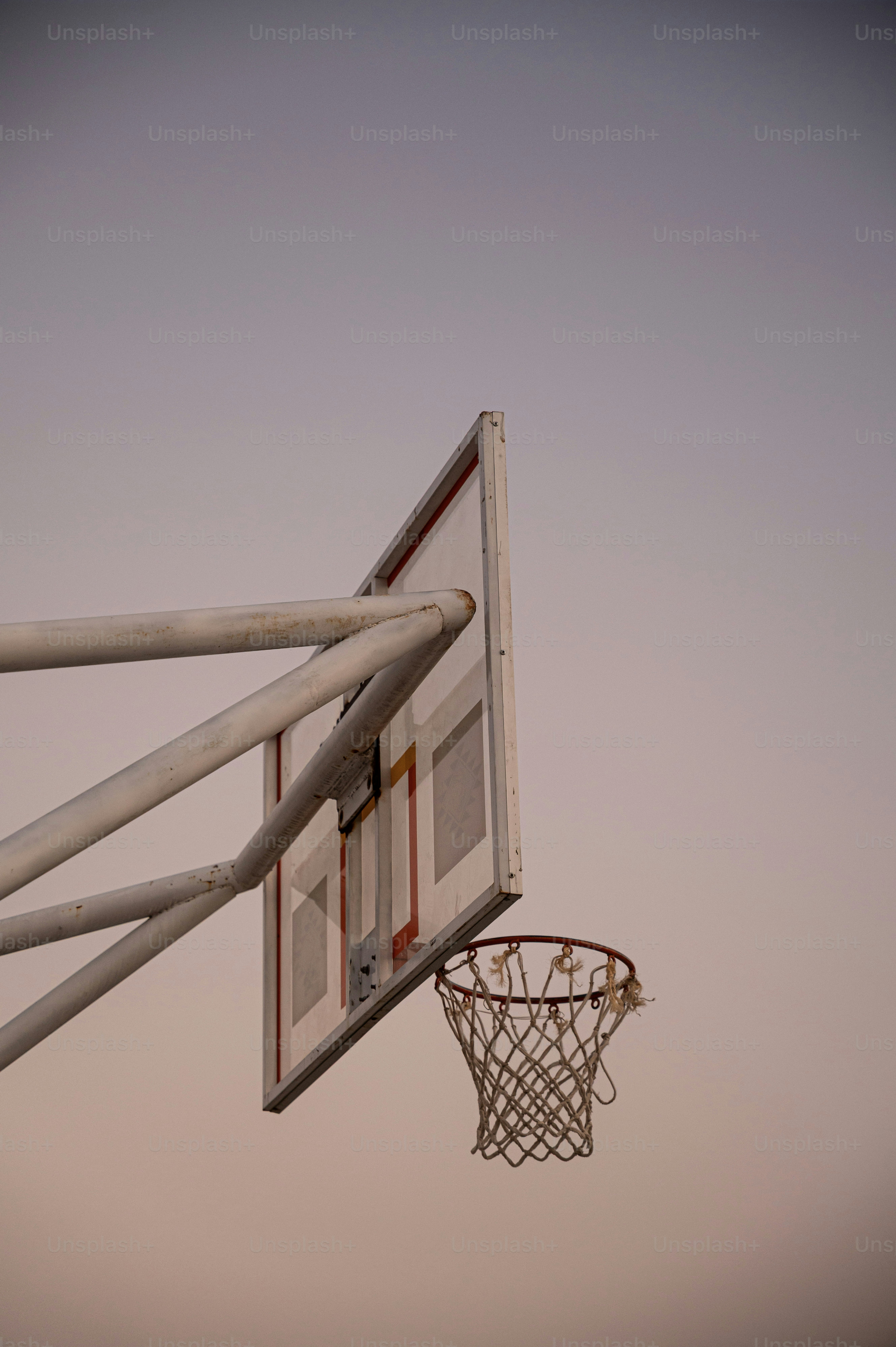 Basketball hoop against a dusky sky