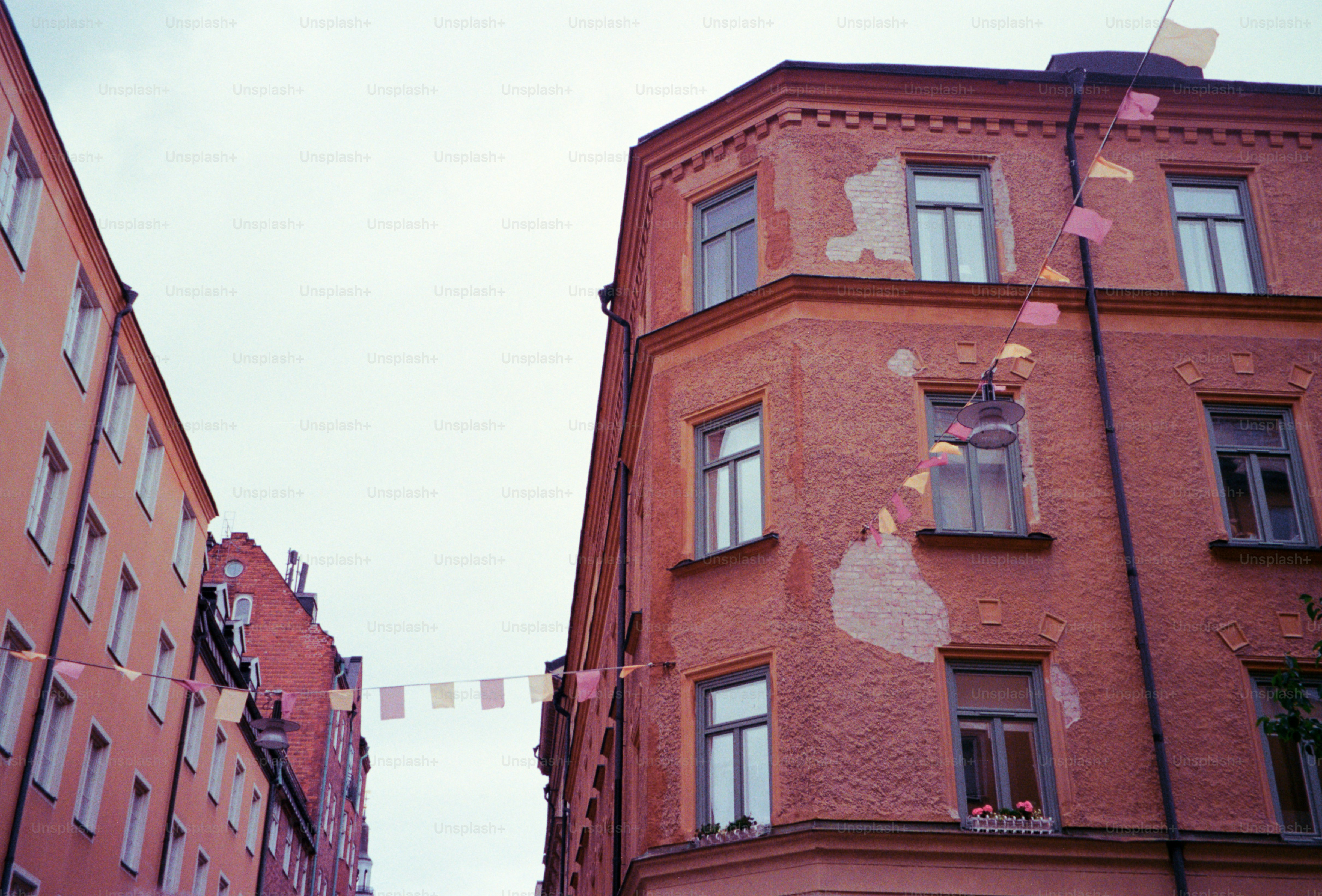 Buildings are decorated with flags on a cloudy day.