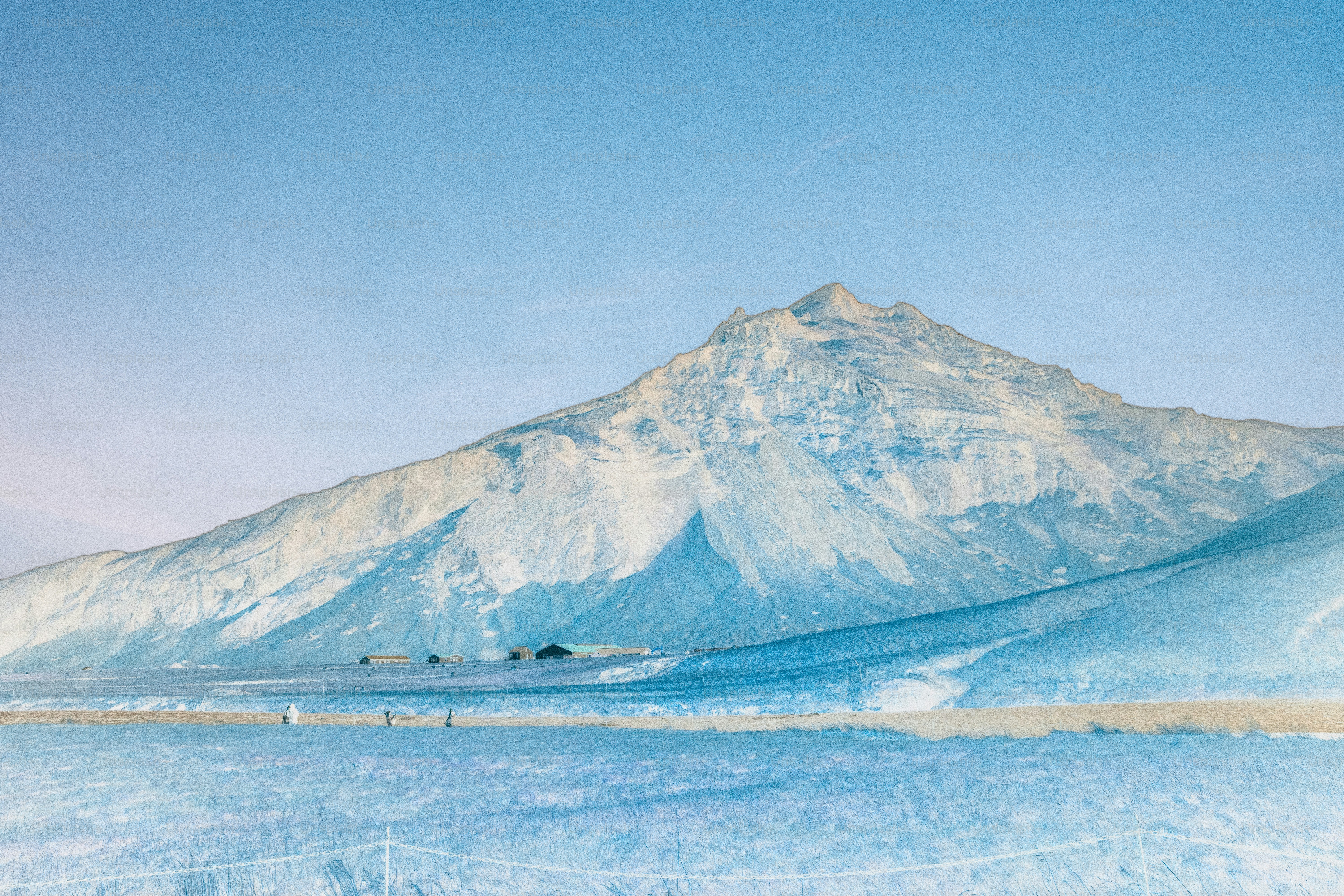 Snow-covered mountain under a clear blue sky.