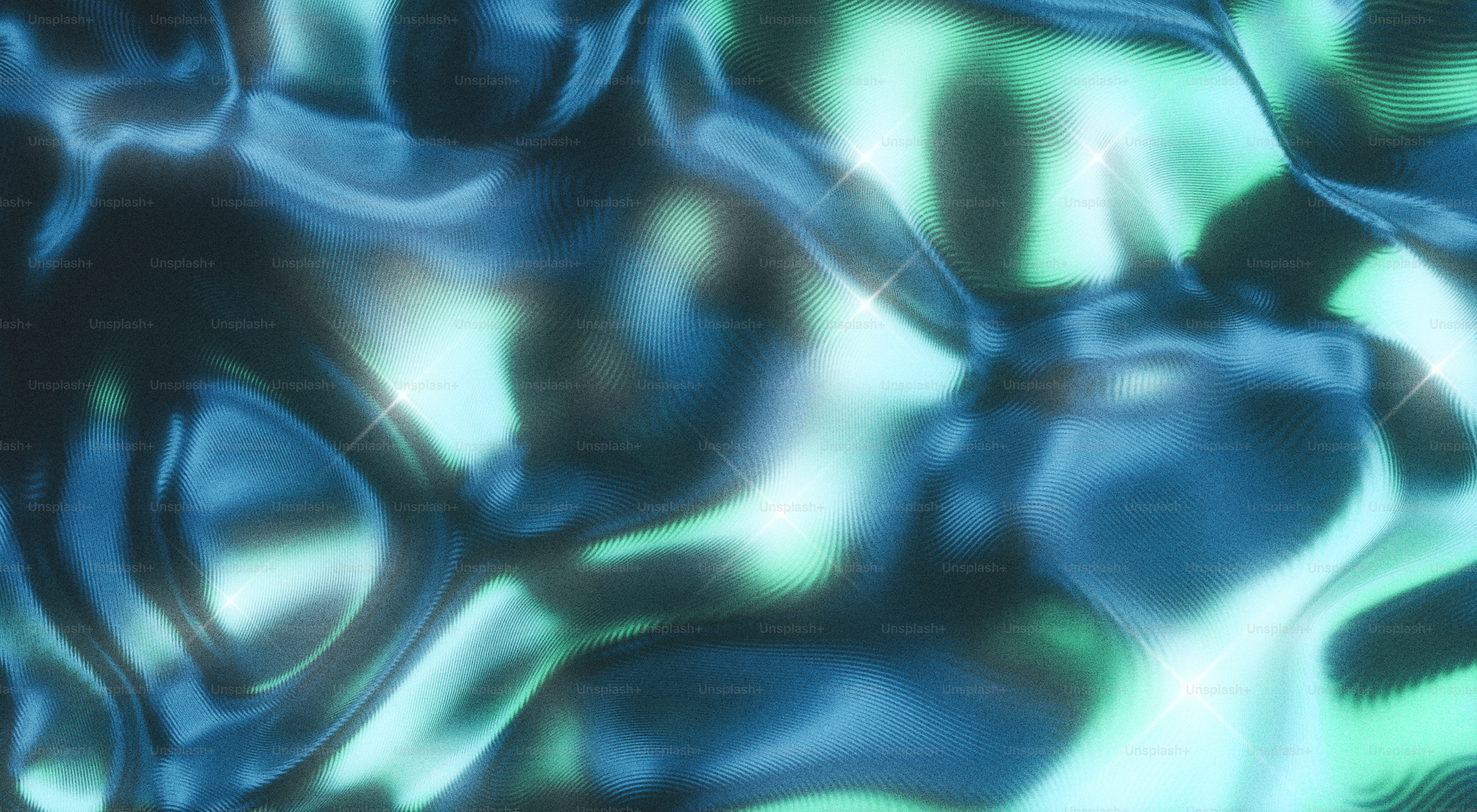 Abstract, rippling liquid with blue and green highlights.