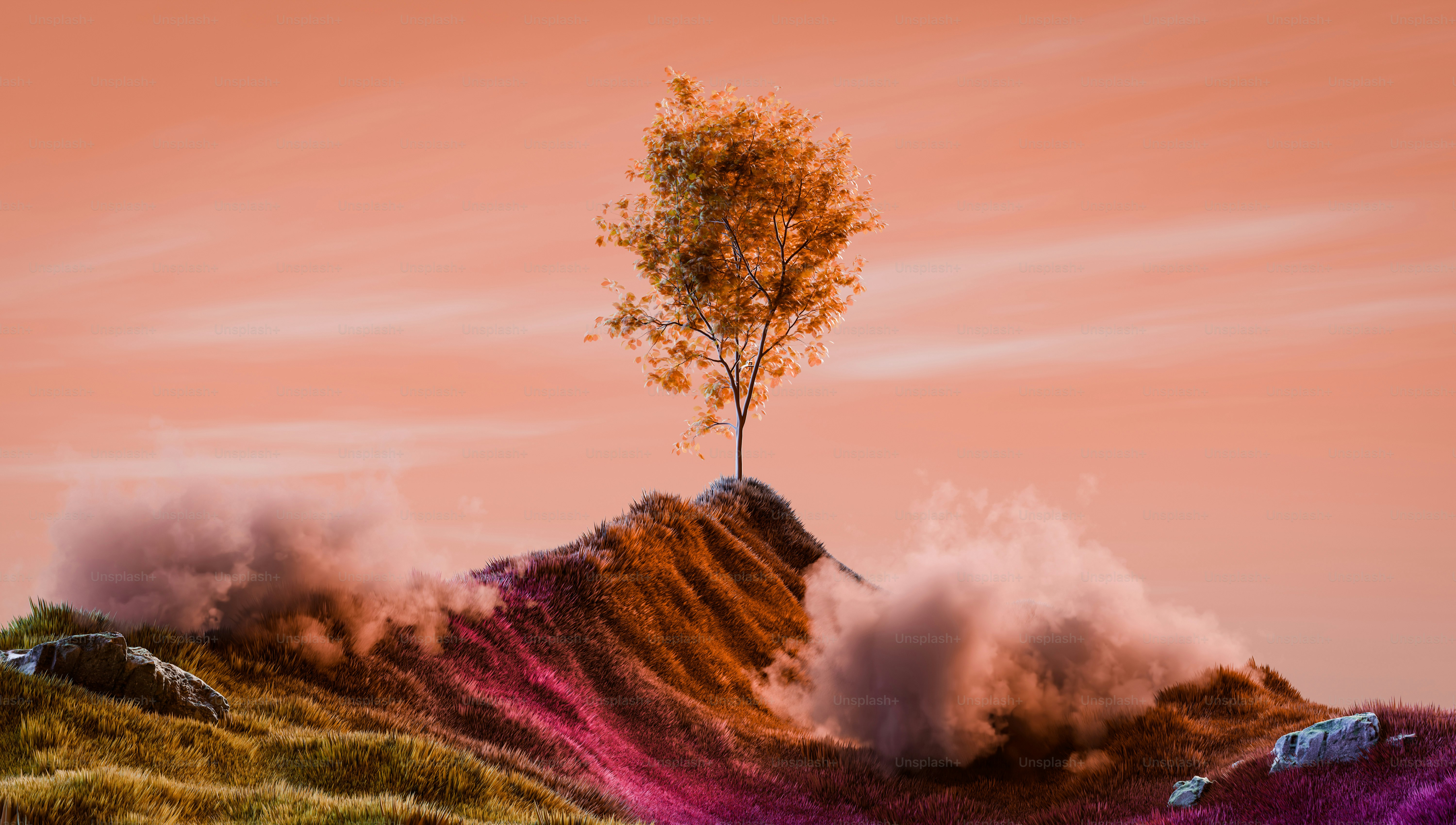 A tree stands alone on a colorful hillside.