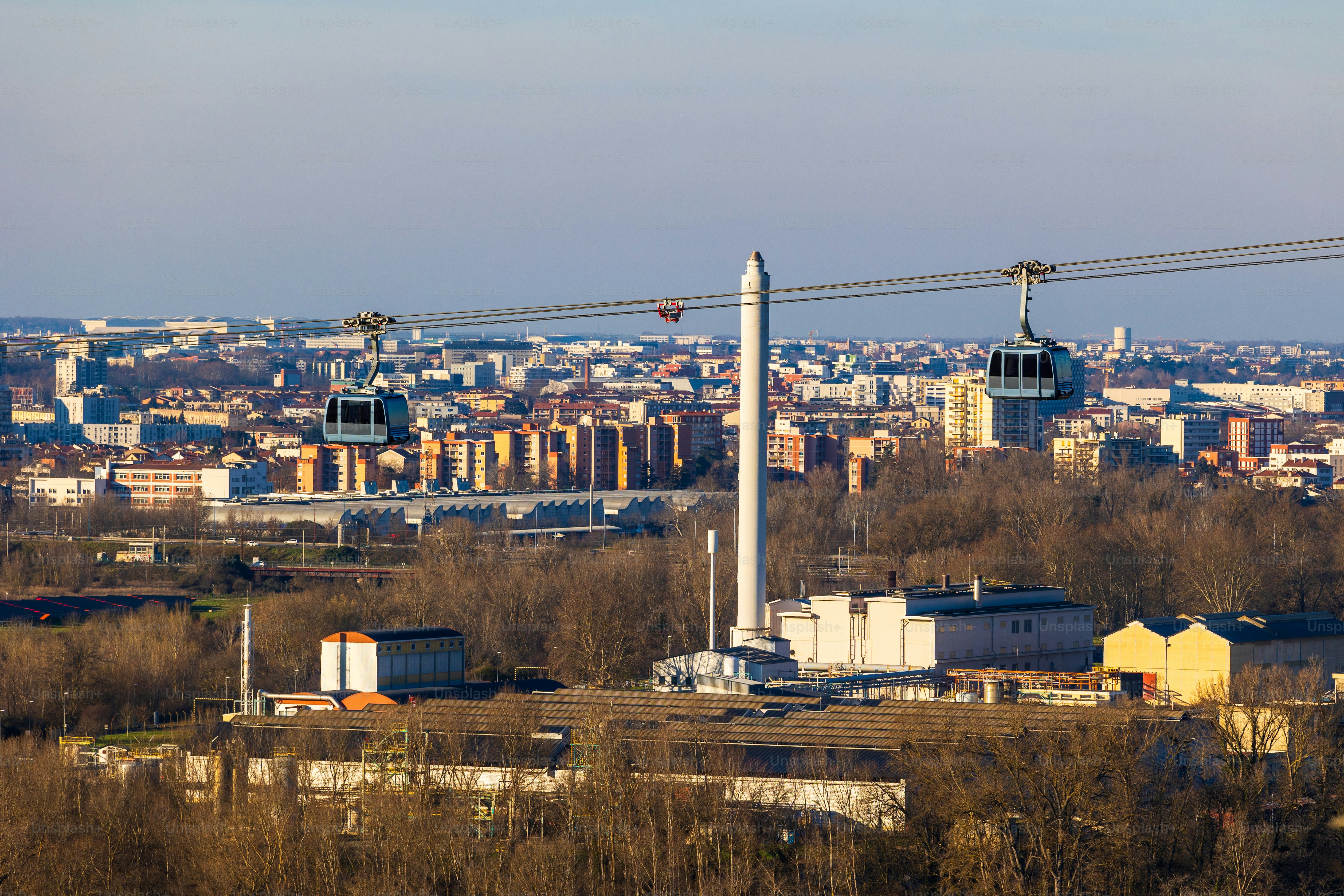 Cabin of Toulouse’s urban cable car above an industrial site on the banks of the Garonne from Puech David