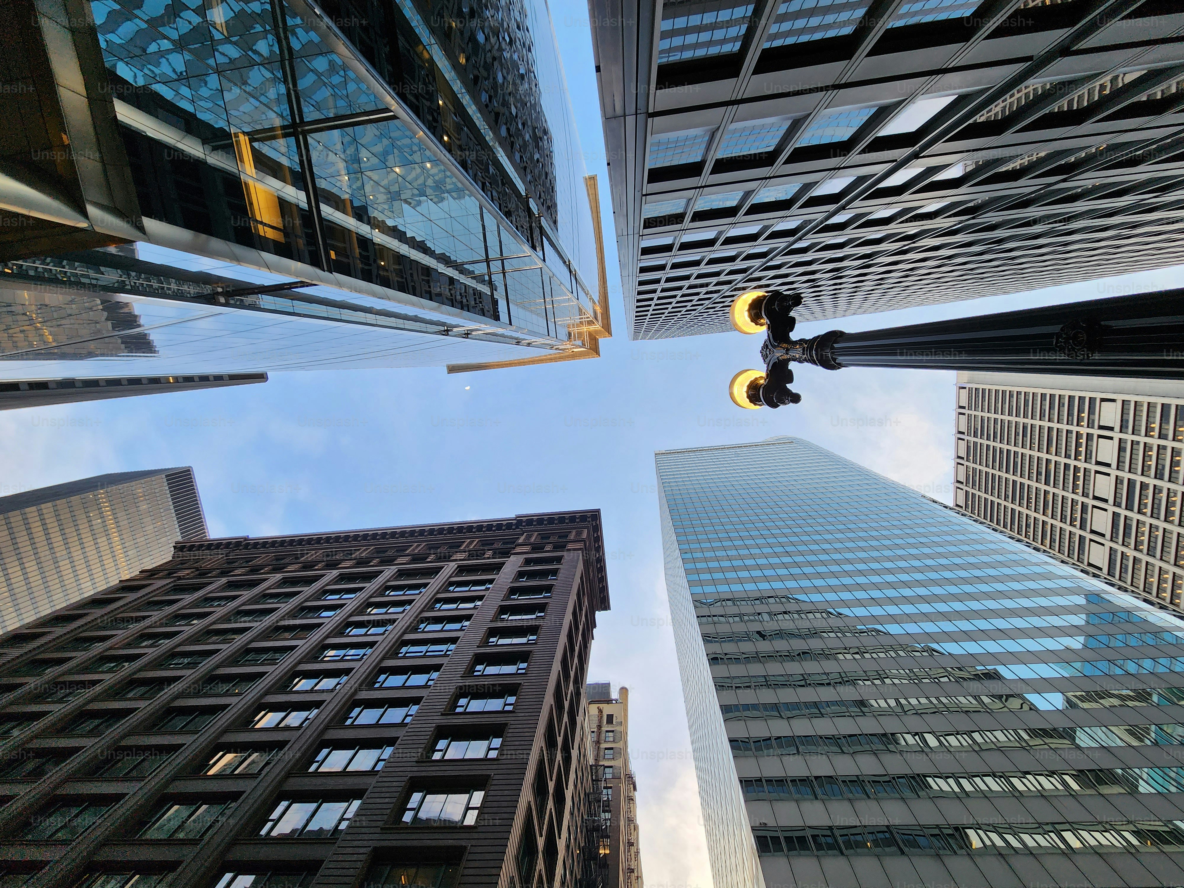 skyscraper building architecture. skyscraper with glassy facade. modern city perspective. skyscraper in metropolis city. city downtown with skyscraper in perspective. perspective low view.