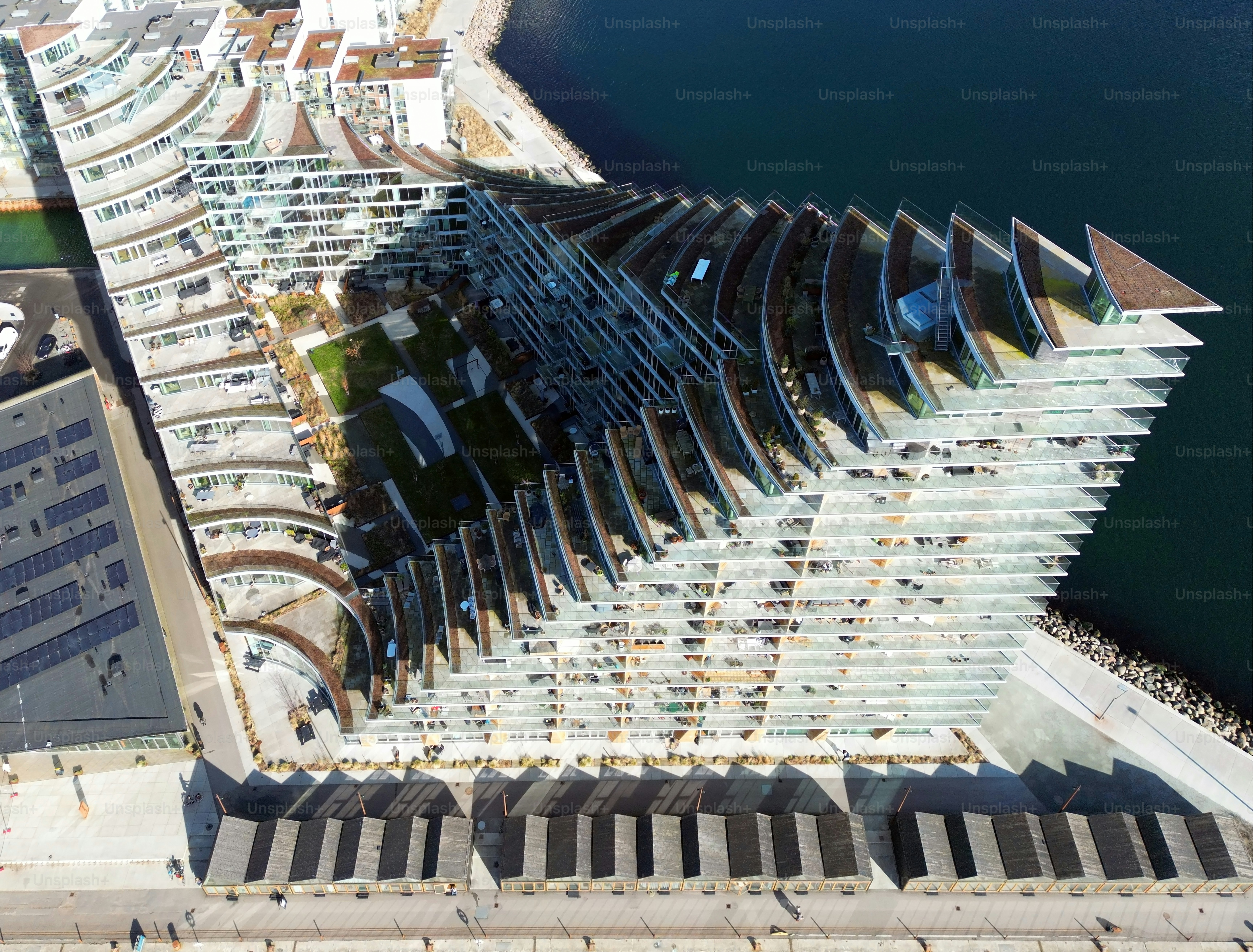 Aerial view of a modern contemporary architectural building with balconys on the waterfront of Aarhus on a sunny day in Jylland - Denmark