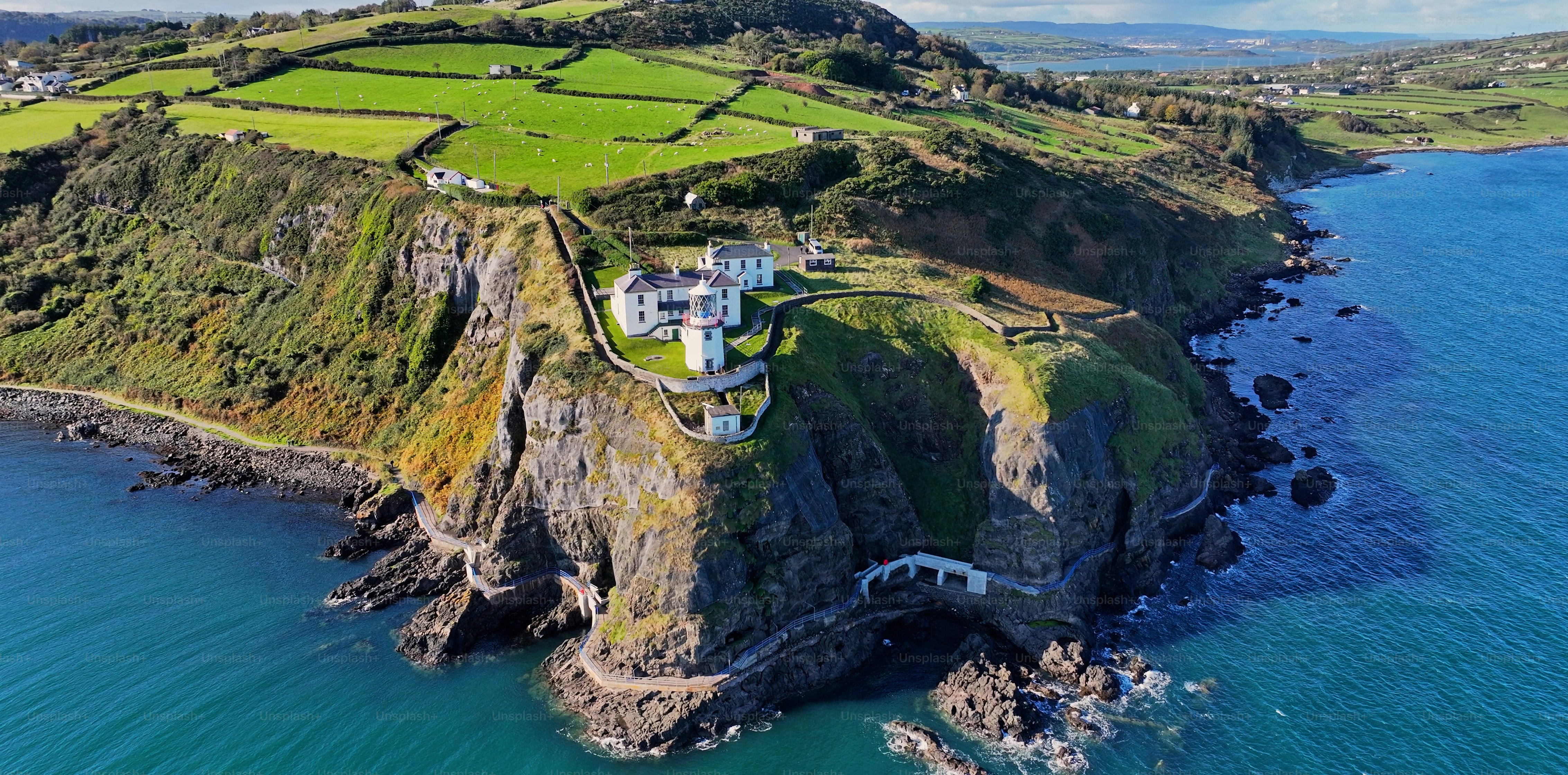 Aerial view of Blackhead Lighthouse on the beautiful and spectacular coastline of the Glens of Antrim Northern Ireland
