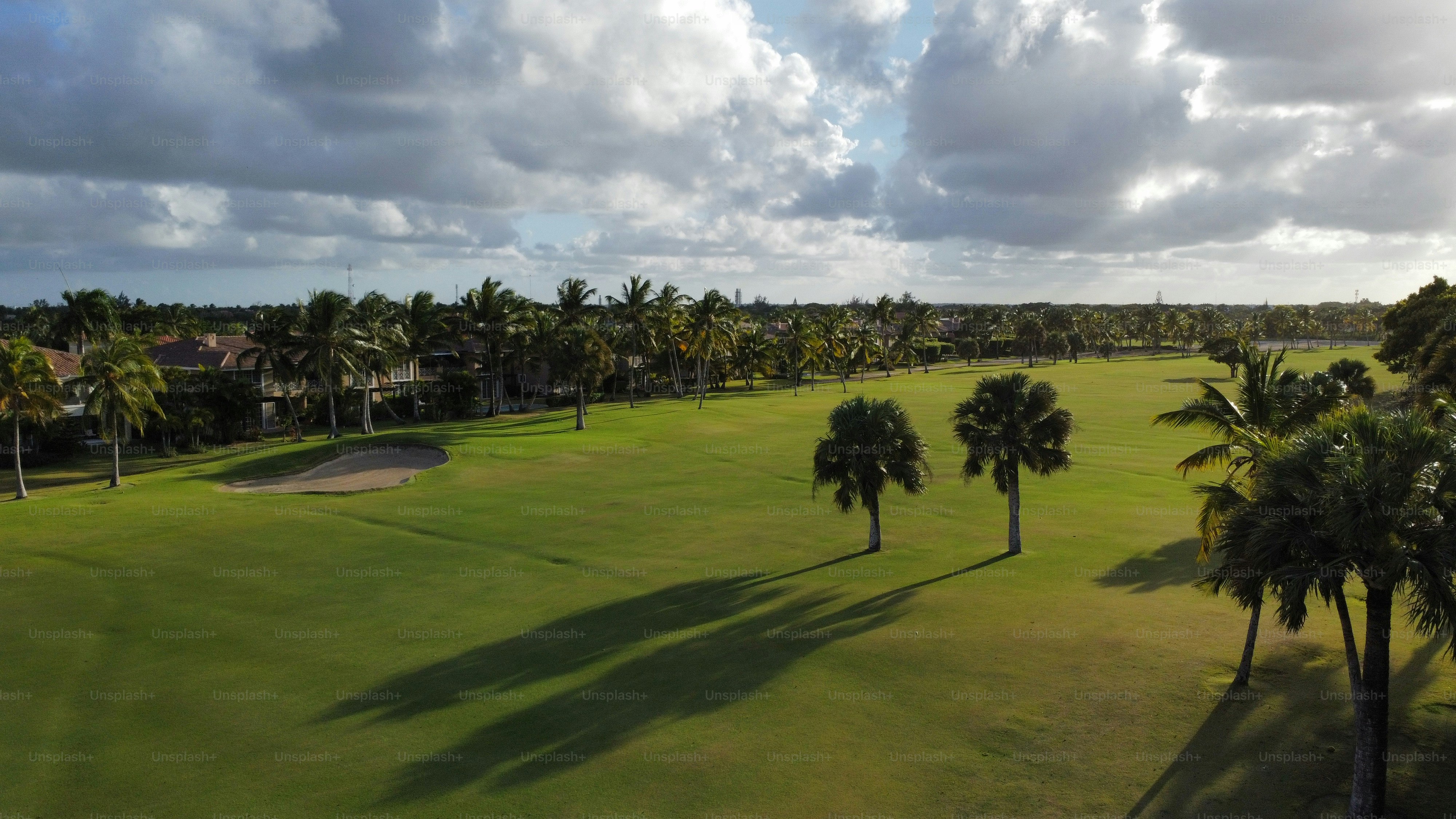 A large golf course is located between the villas. Beautiful well-groomed area with grass and palm trees
