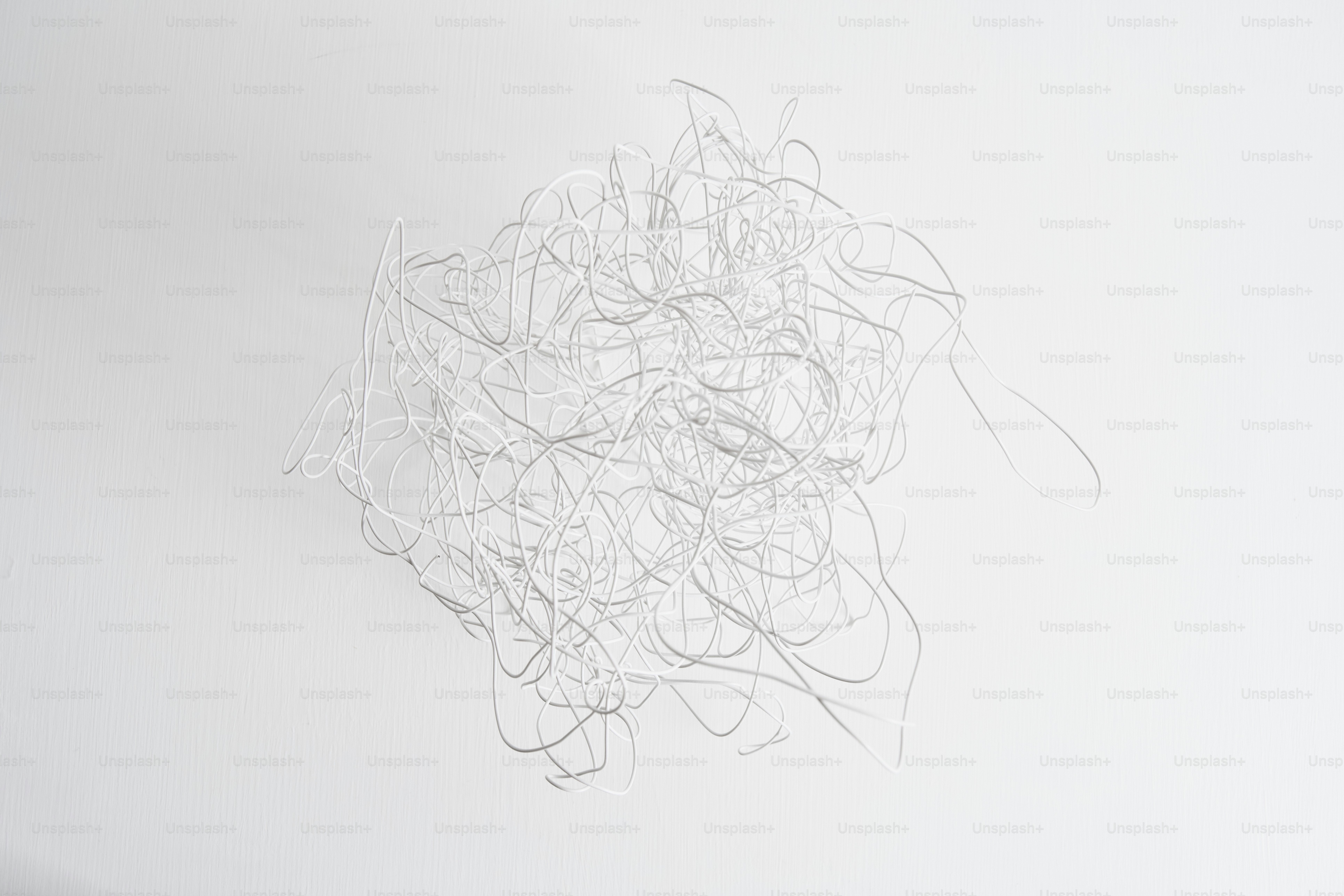 A tangled pile of white, thin strings.
