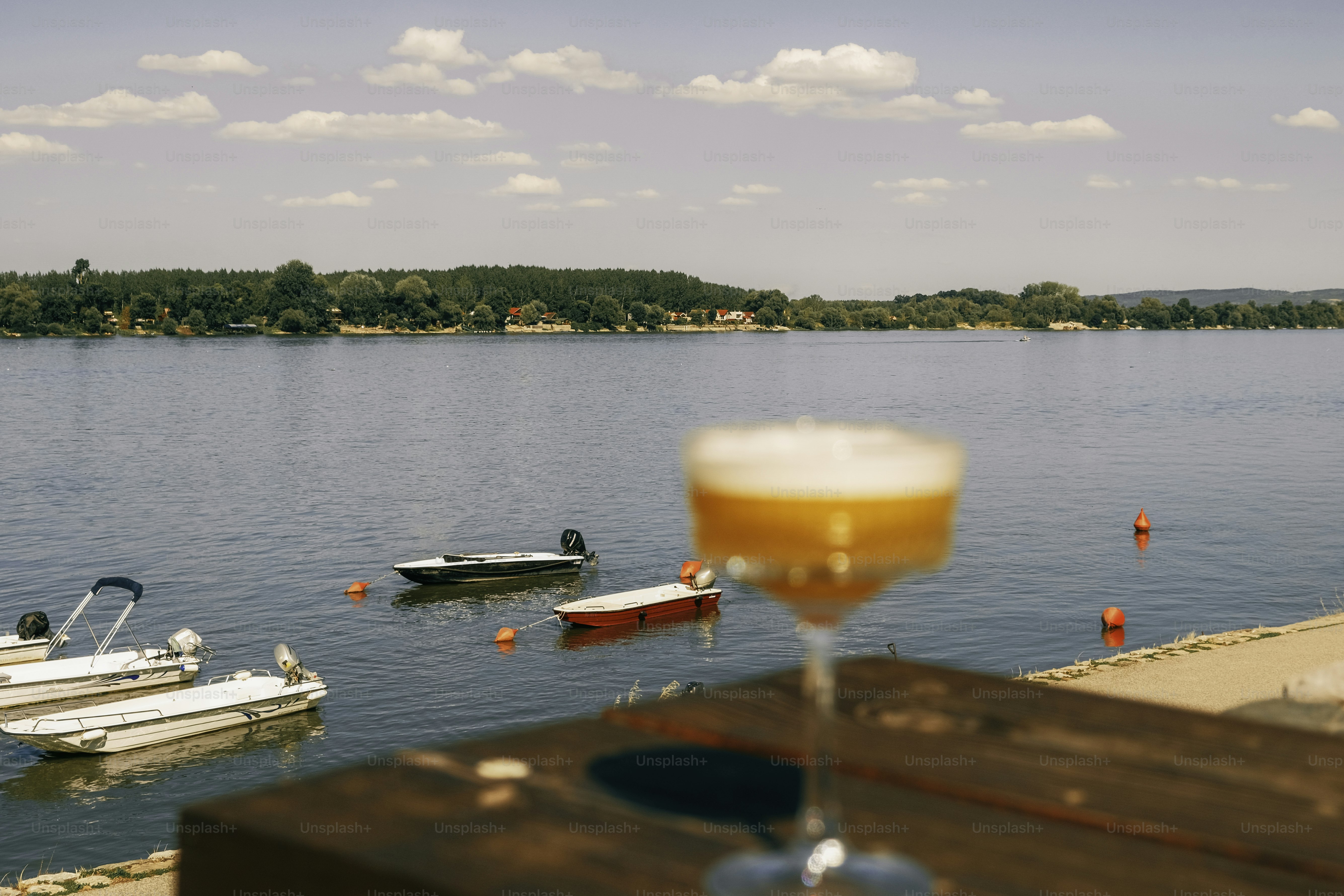 A drink cheers with boats and the water view.