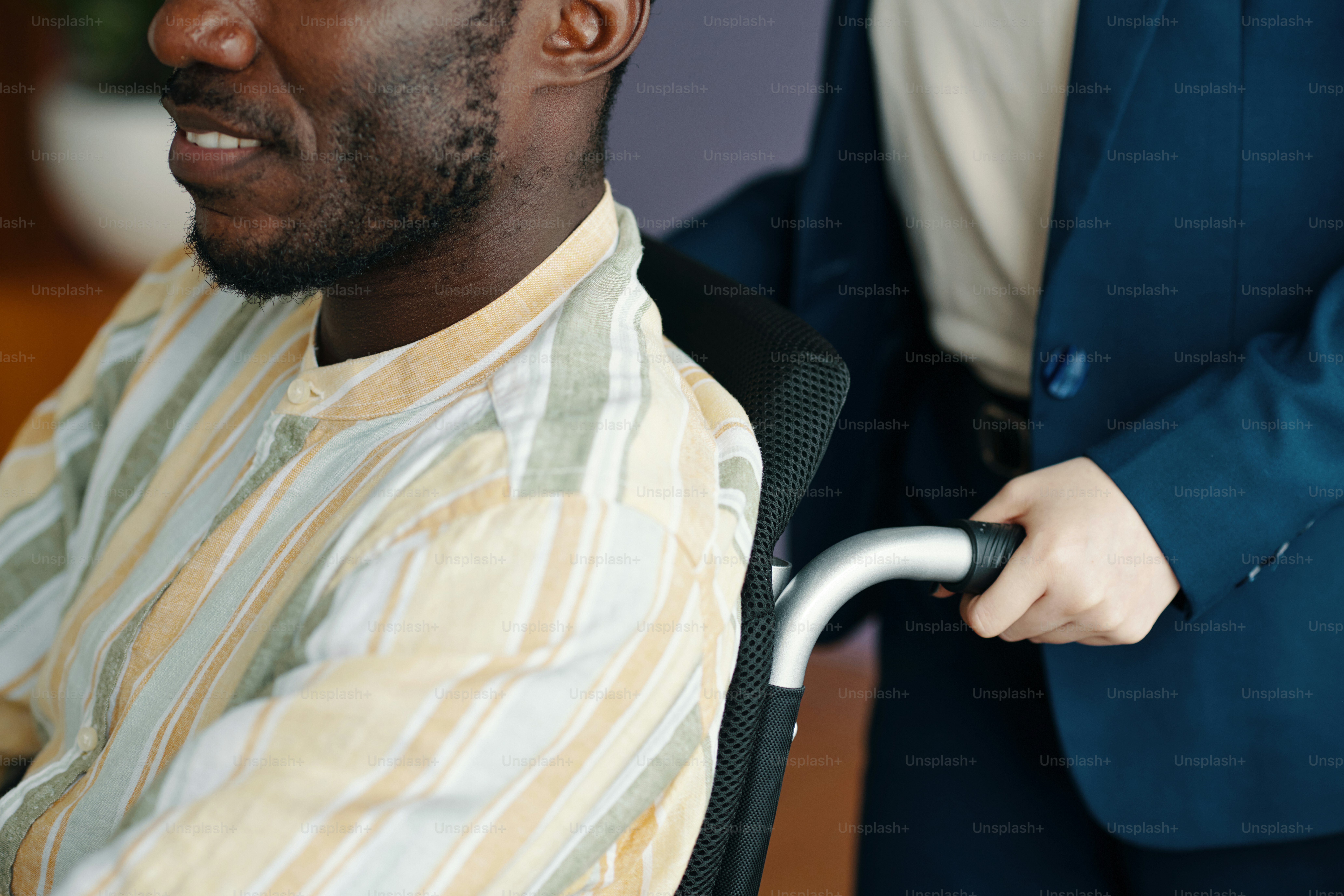 Close-up of woman helping her colleague with disability in office