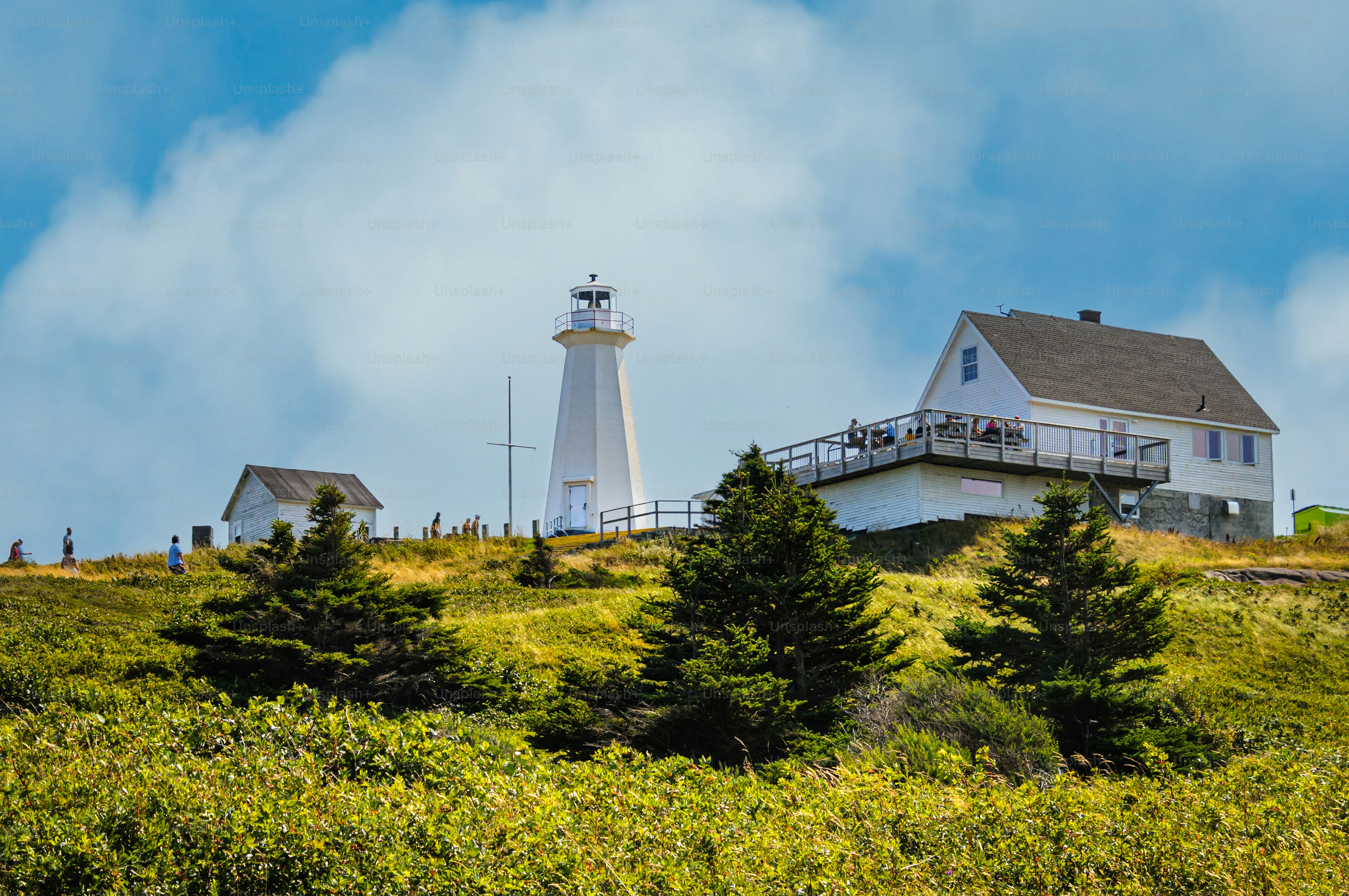 Visitors hike to the Cape Spear Lighthouse (1955) in St. John's Newfoundland overlooking the easternmost point of Canada.
