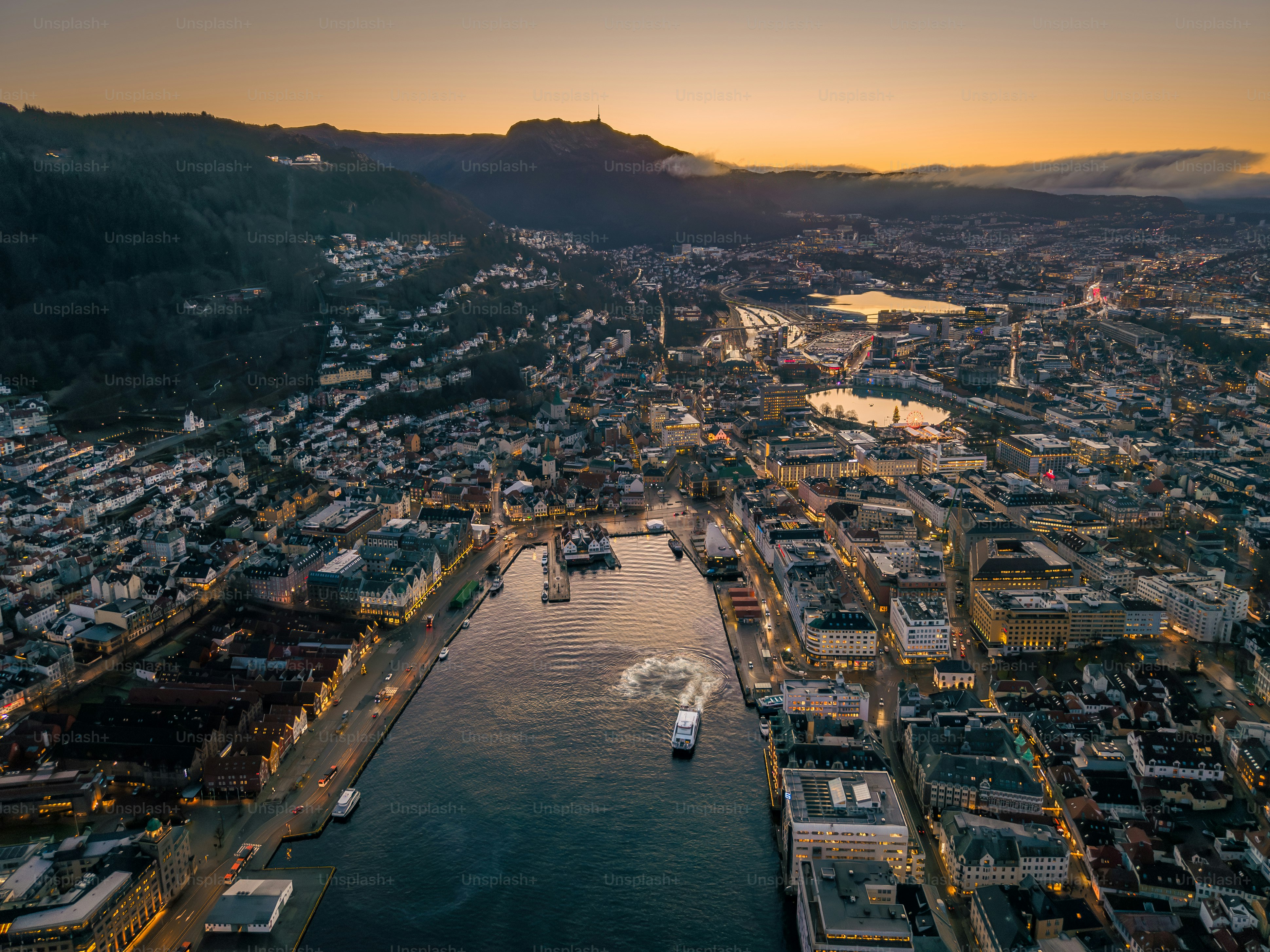 Night aerial of historic wooden Hanseatic fjord town Bergen, Norway
