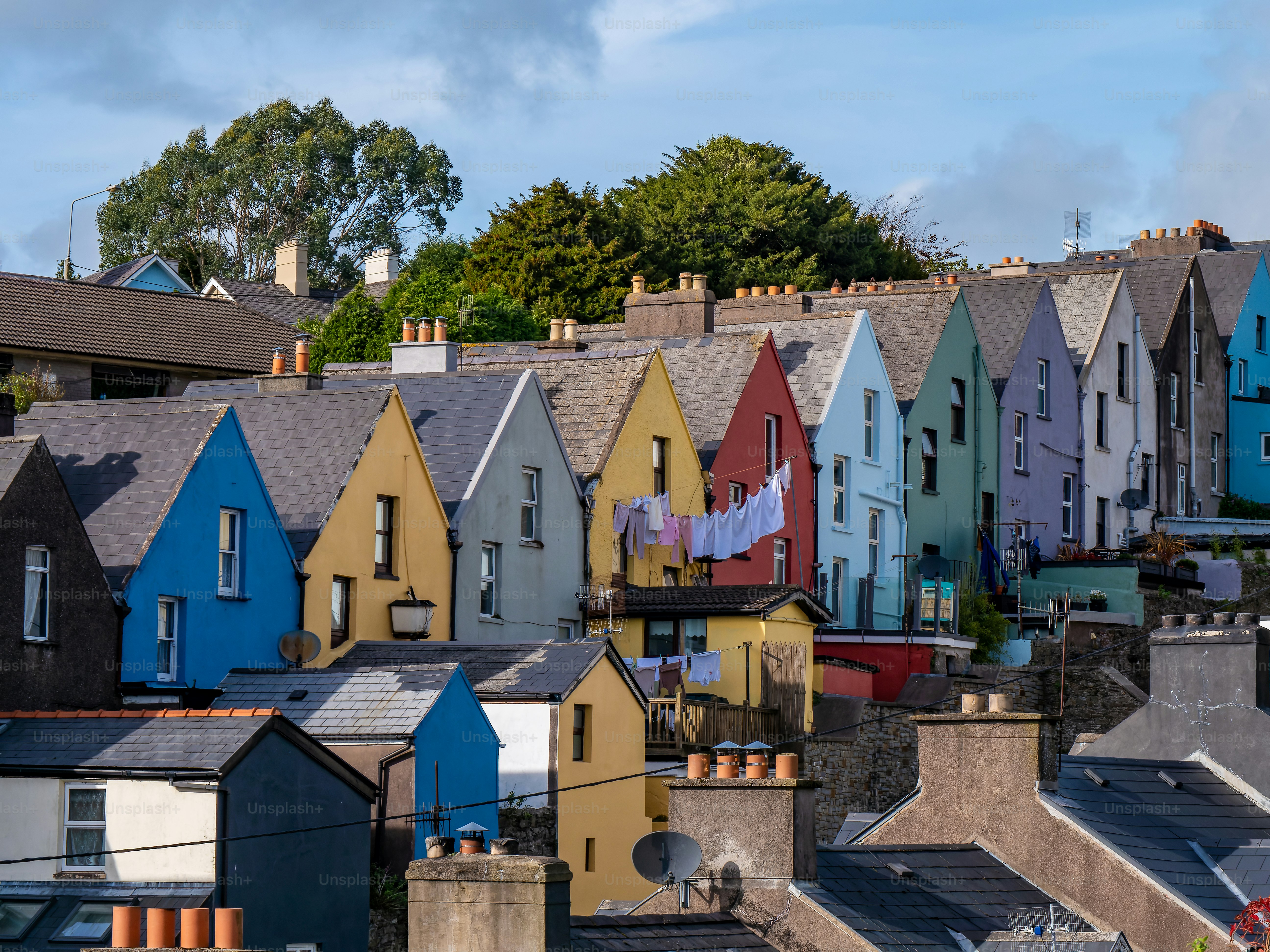 Multicolored European houses, street of the small Irish town of Cobh, urban landscape. Blue sky over the city. Houses under blue sky