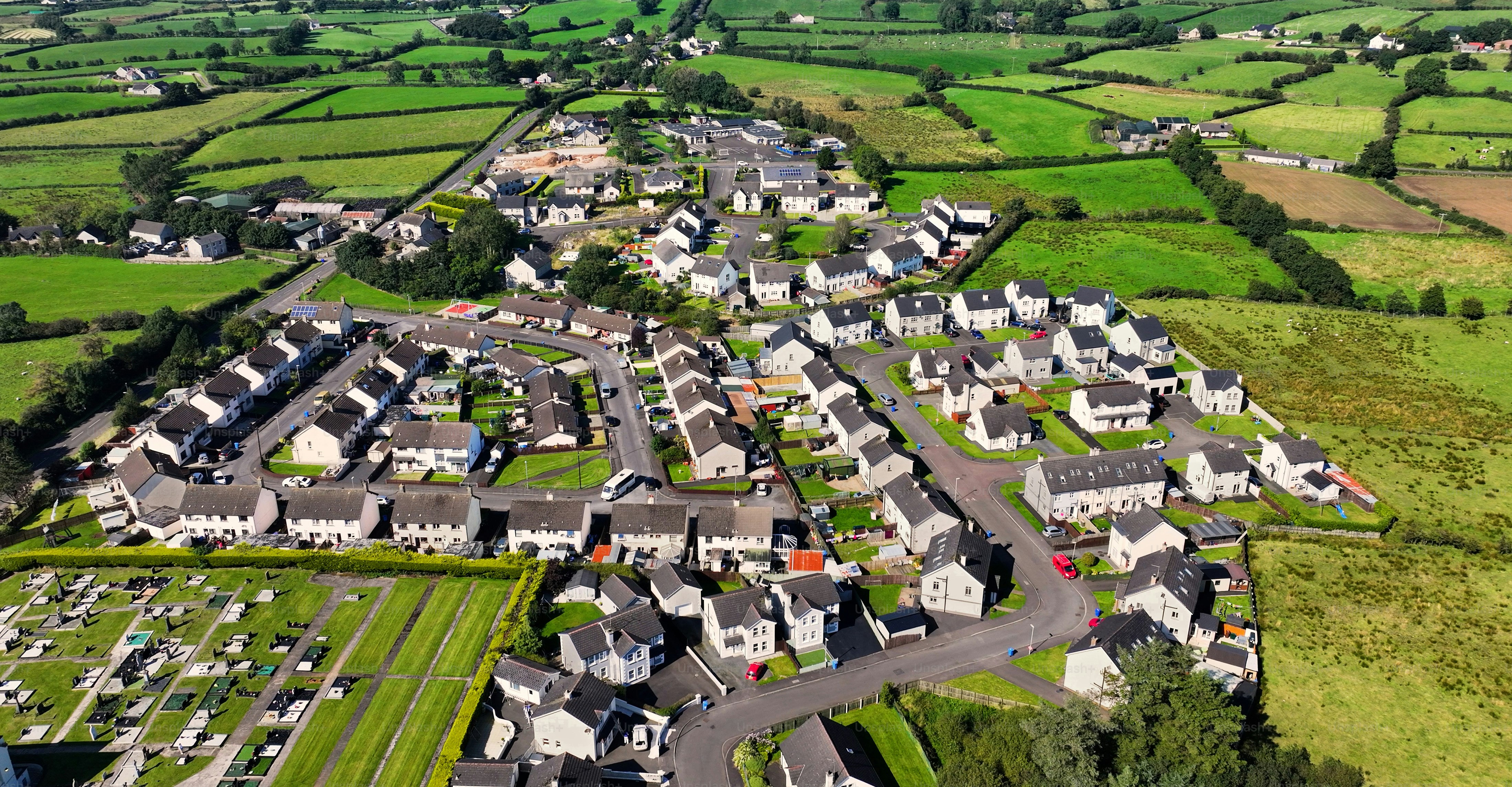 Aerial view of Residential homes, town houses, bungalows, housing, in Loughguile village Co Antrim Northern Ireland