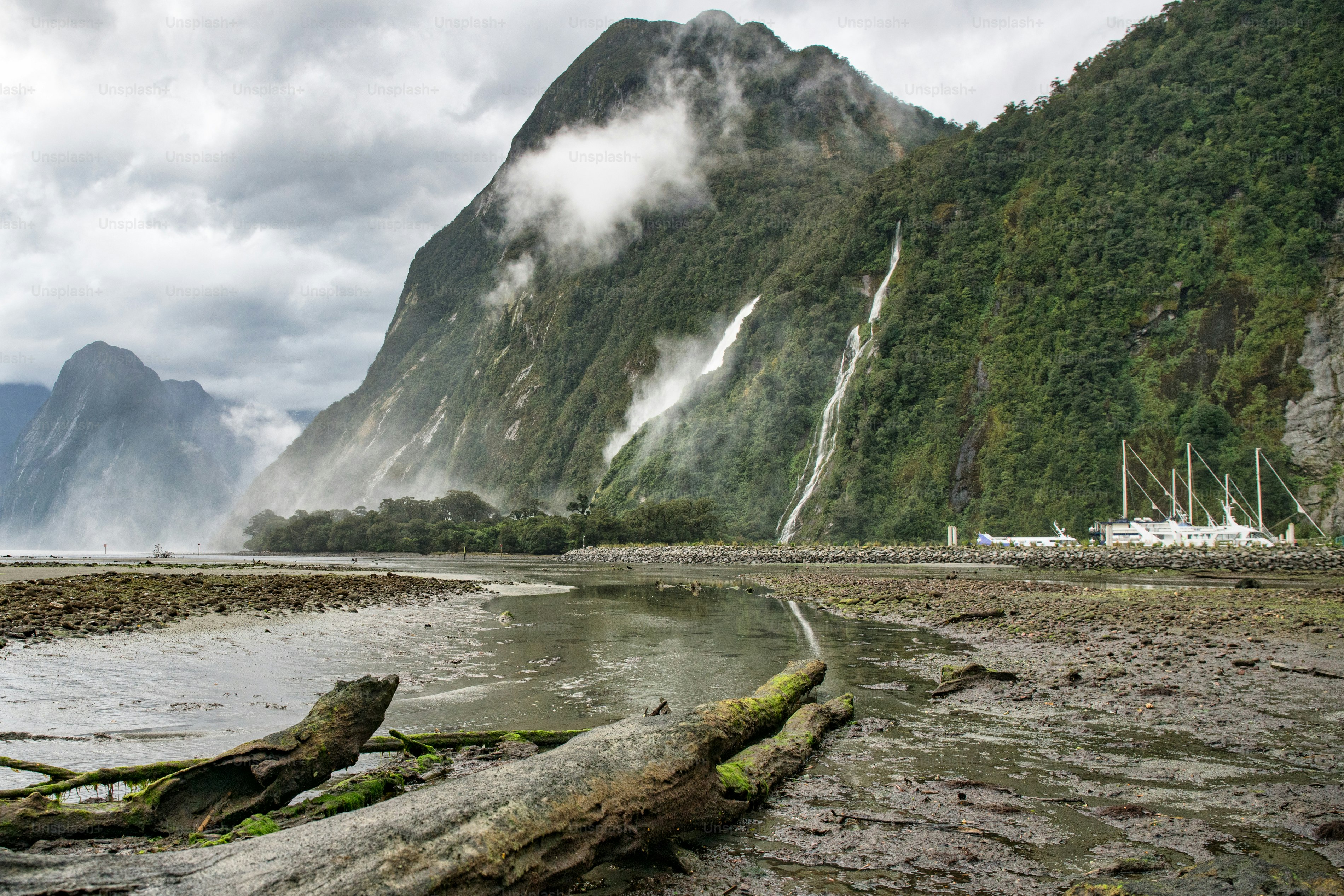 Waterfall and Mitre peak kiews on an overcast day at Milford Sound