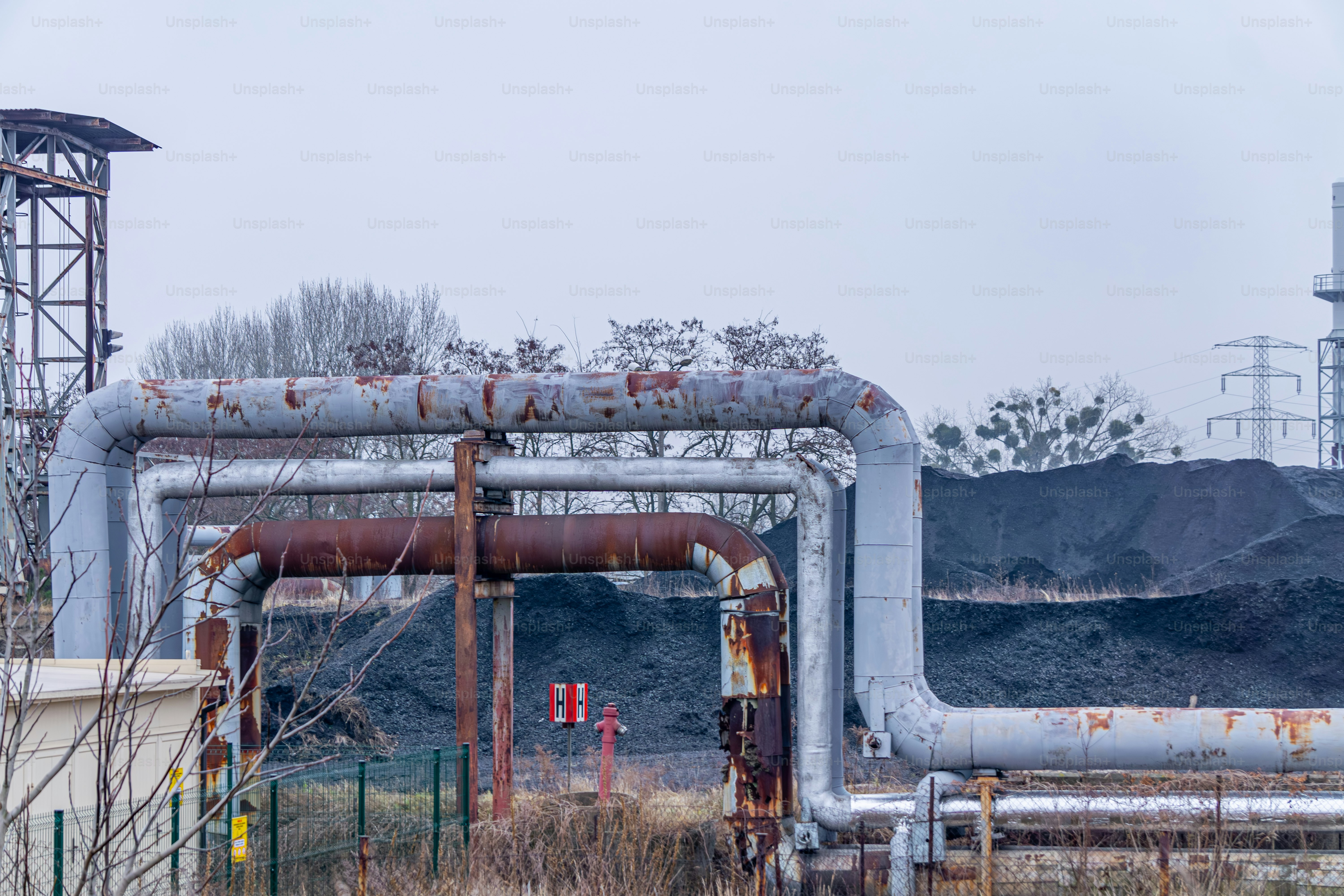 pipes running from the municipal heat and power plant to the city. coal on the premises of a coal-fired power plant. not an ecological source of heating for the city