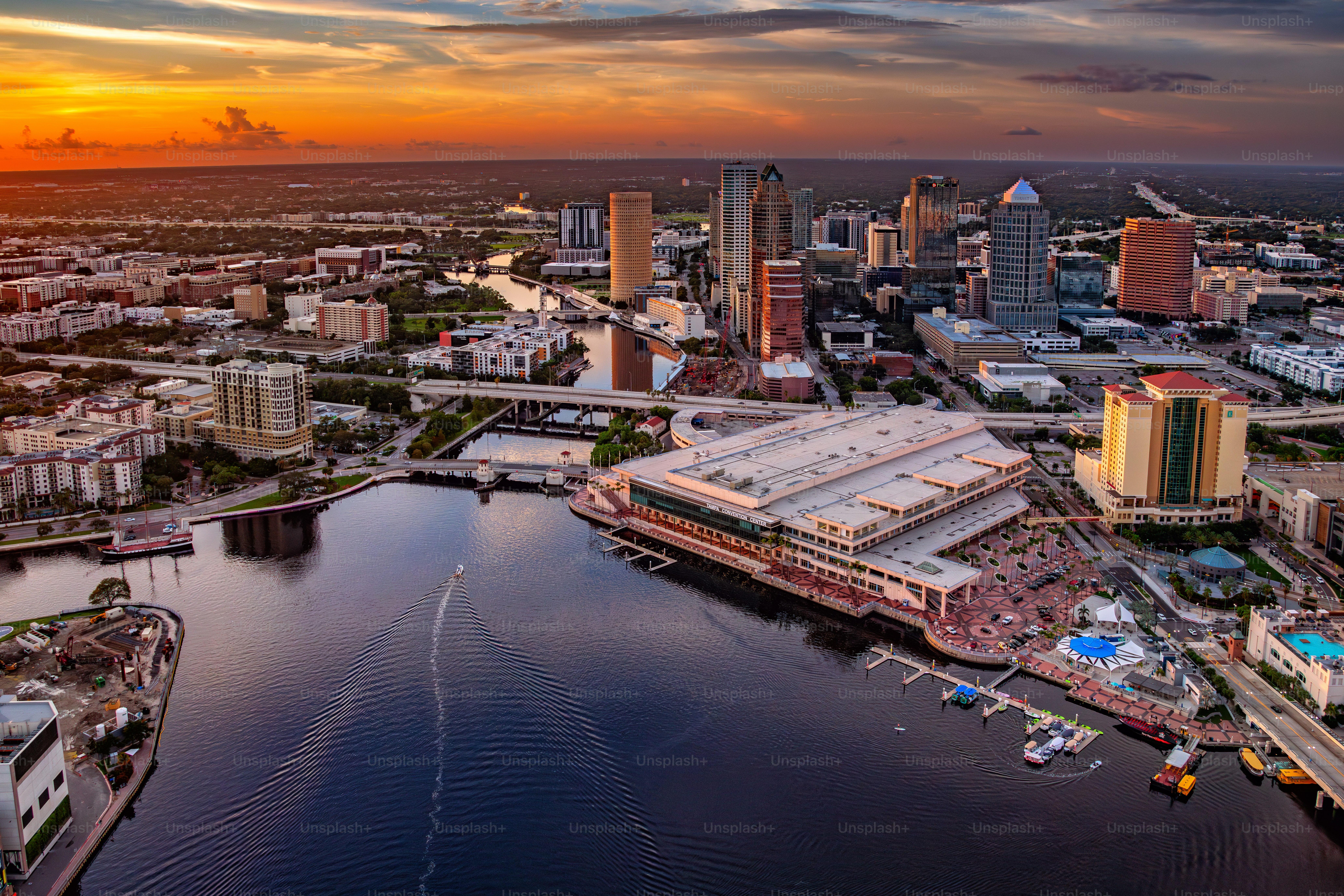 The beautiful downtown district of Tampa Florida along the Hillsborough River shot via helicopter from an altitude of about 600 feet at sunset.