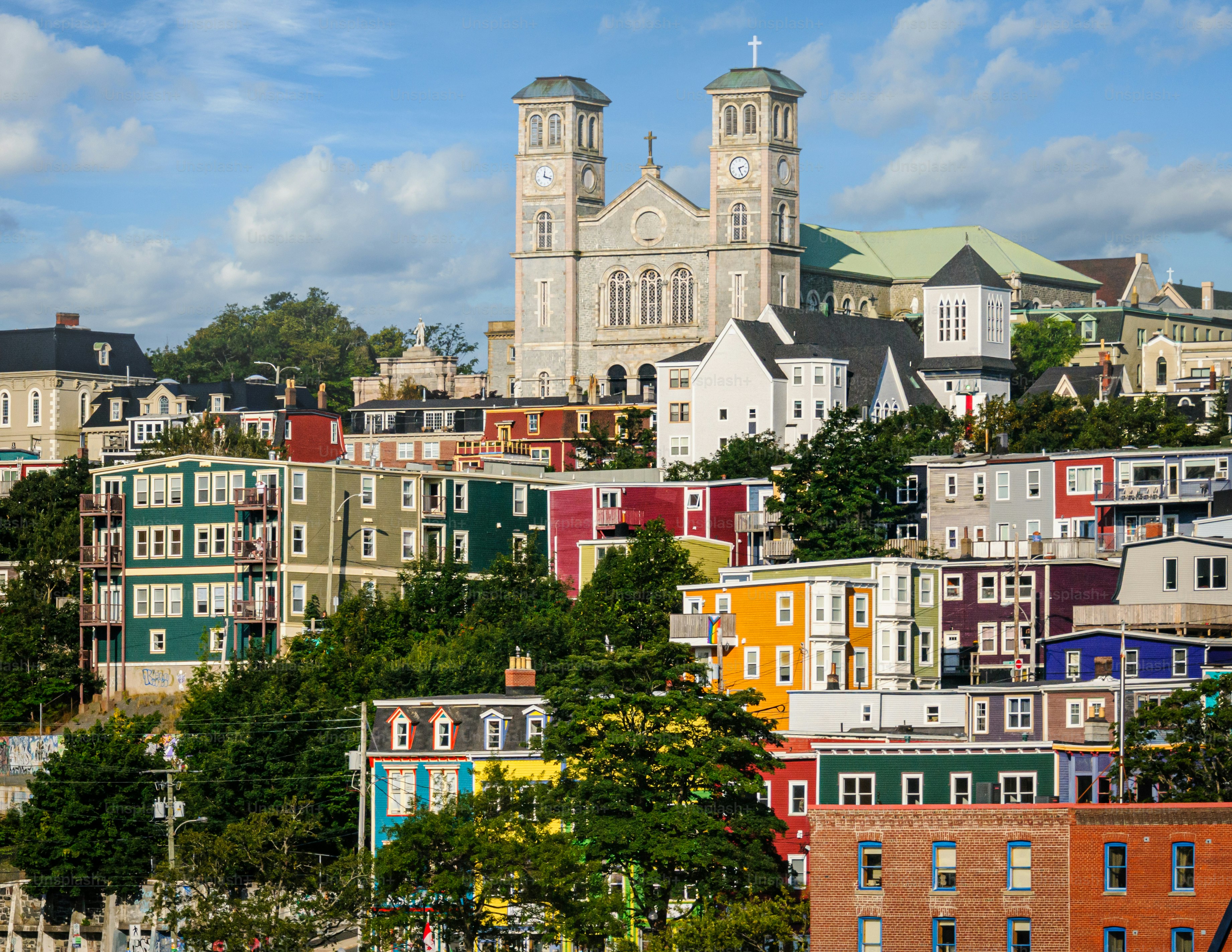 The  Basilica of St. John the Baptist stands tall above the colorful neighborhoods above the piers of St. John's, Newfoundland.