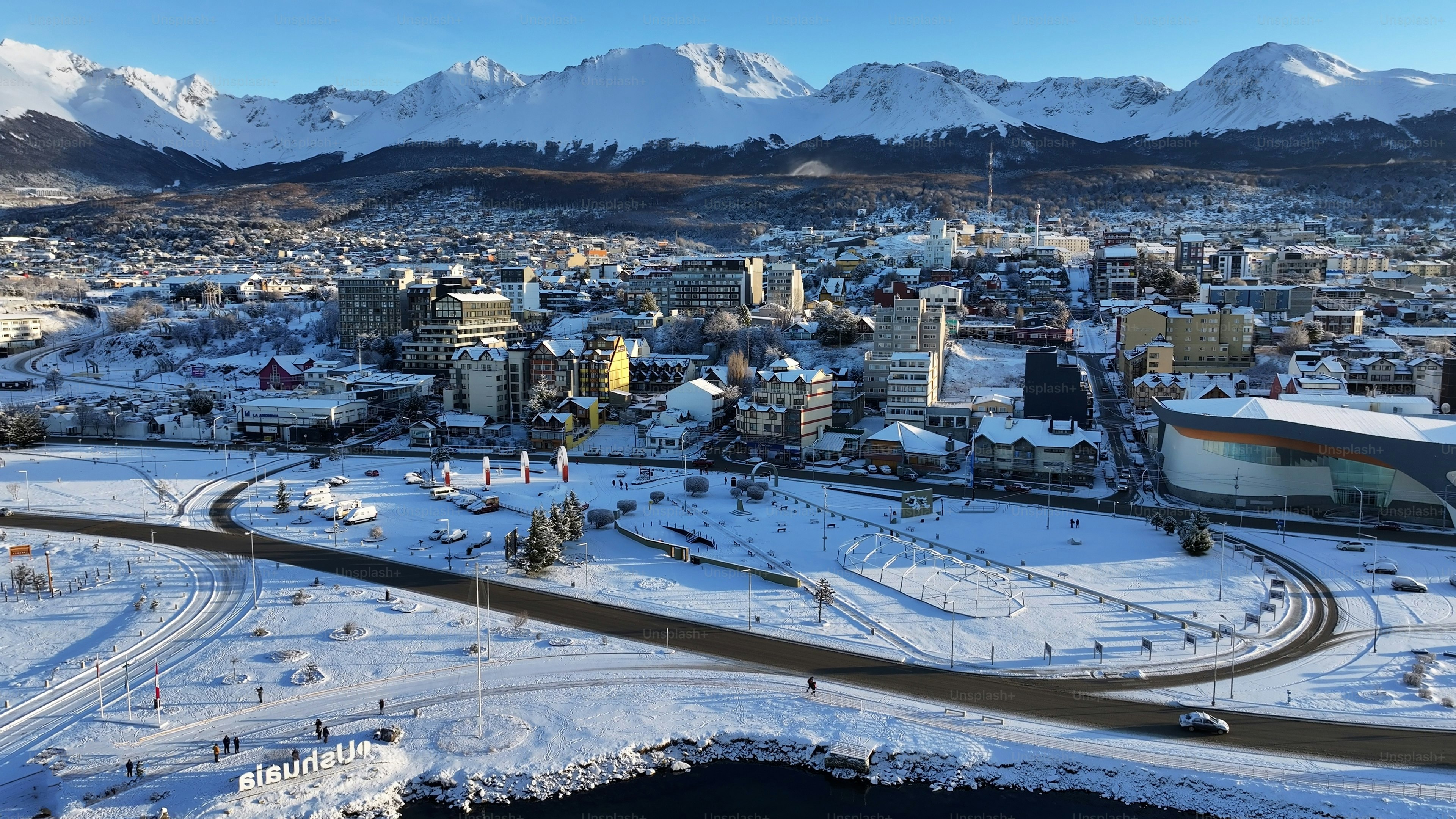 Aerial view of the snow-covered city of Ushuaia with mountains in the background