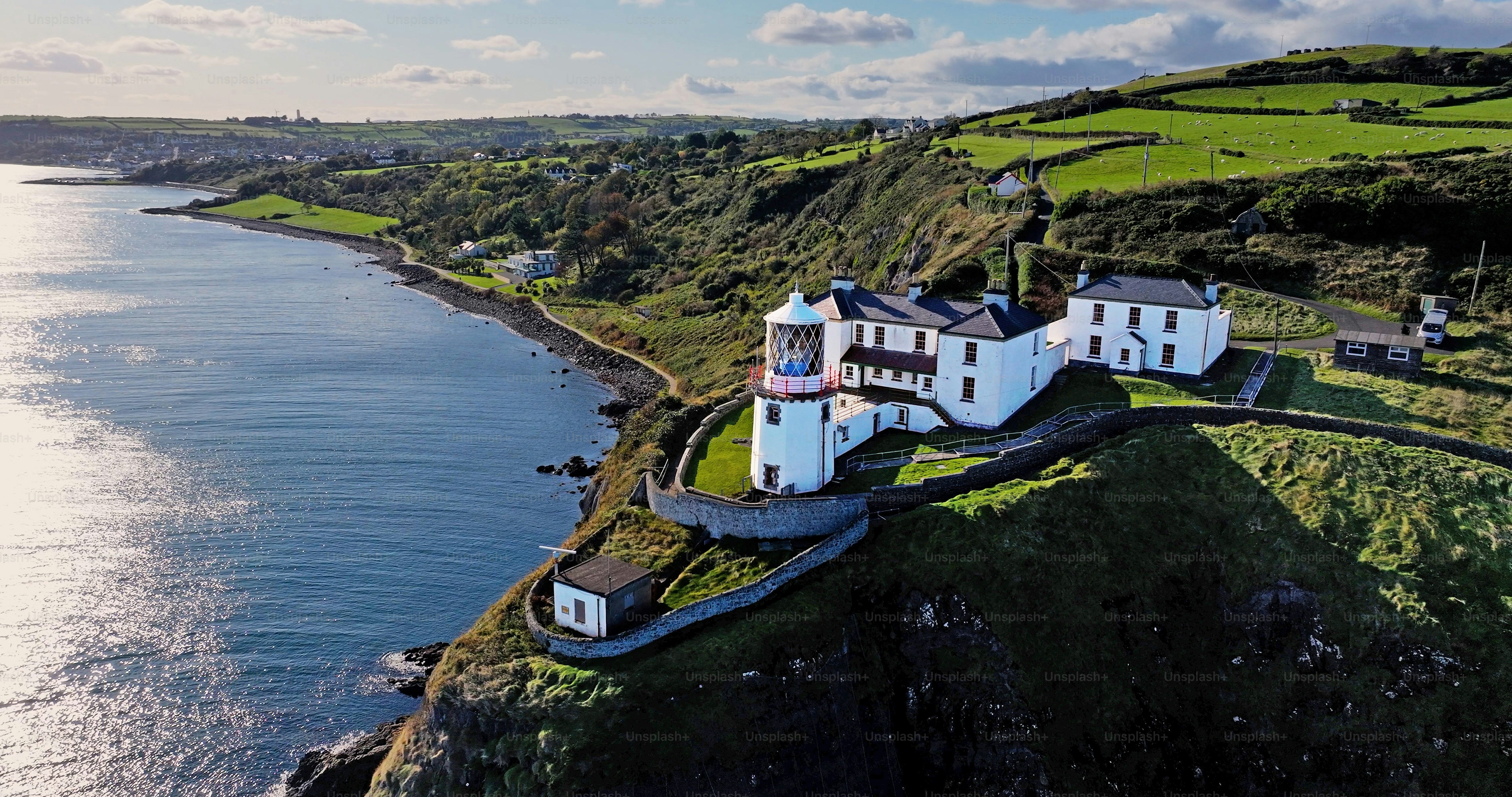 Aerial view of Blackhead Lighthouse on the beautiful and spectacular coastline of the Glens of Antrim Northern Ireland