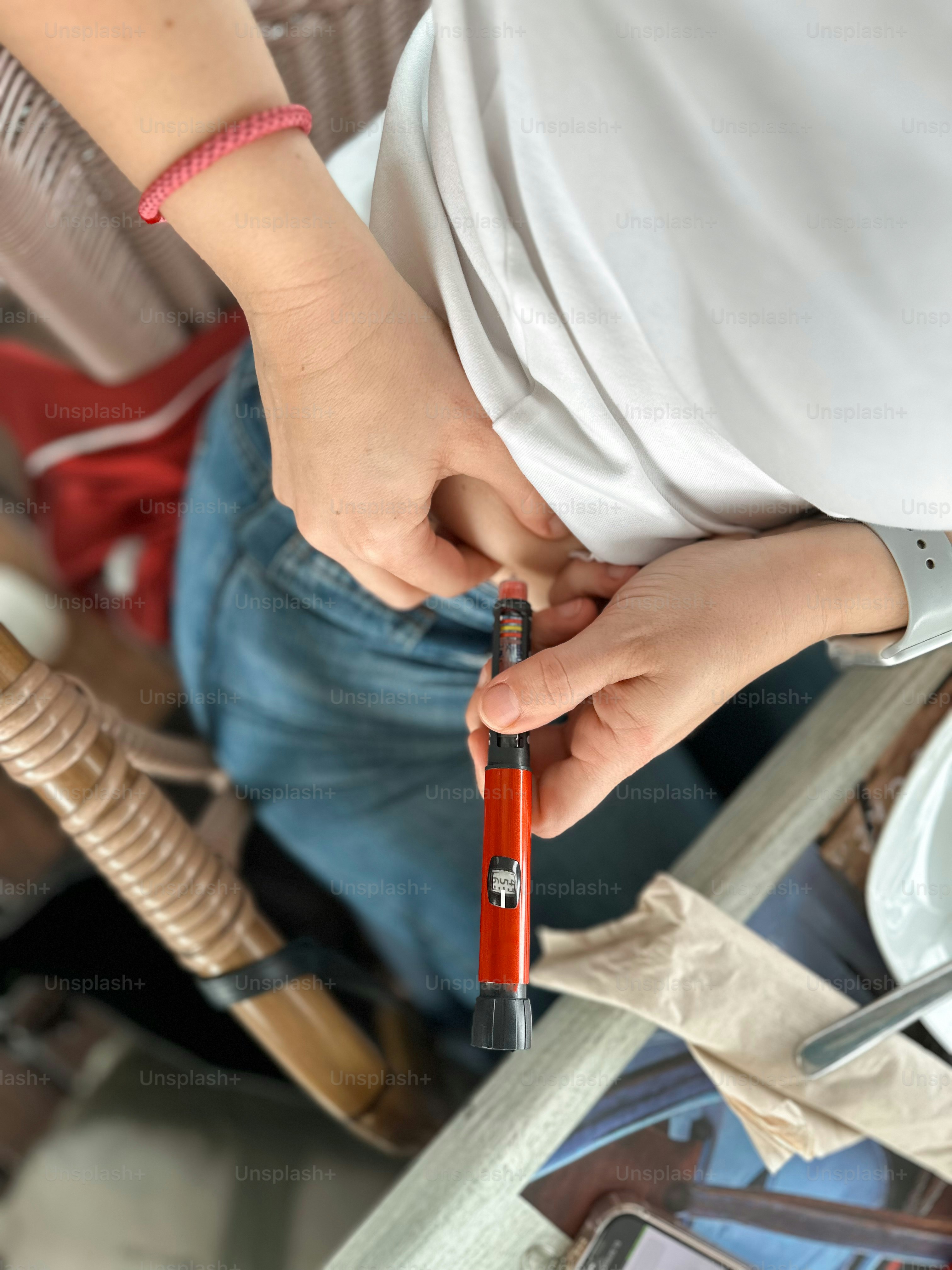 Woman with diabetes injecting insulin with an injection pen.