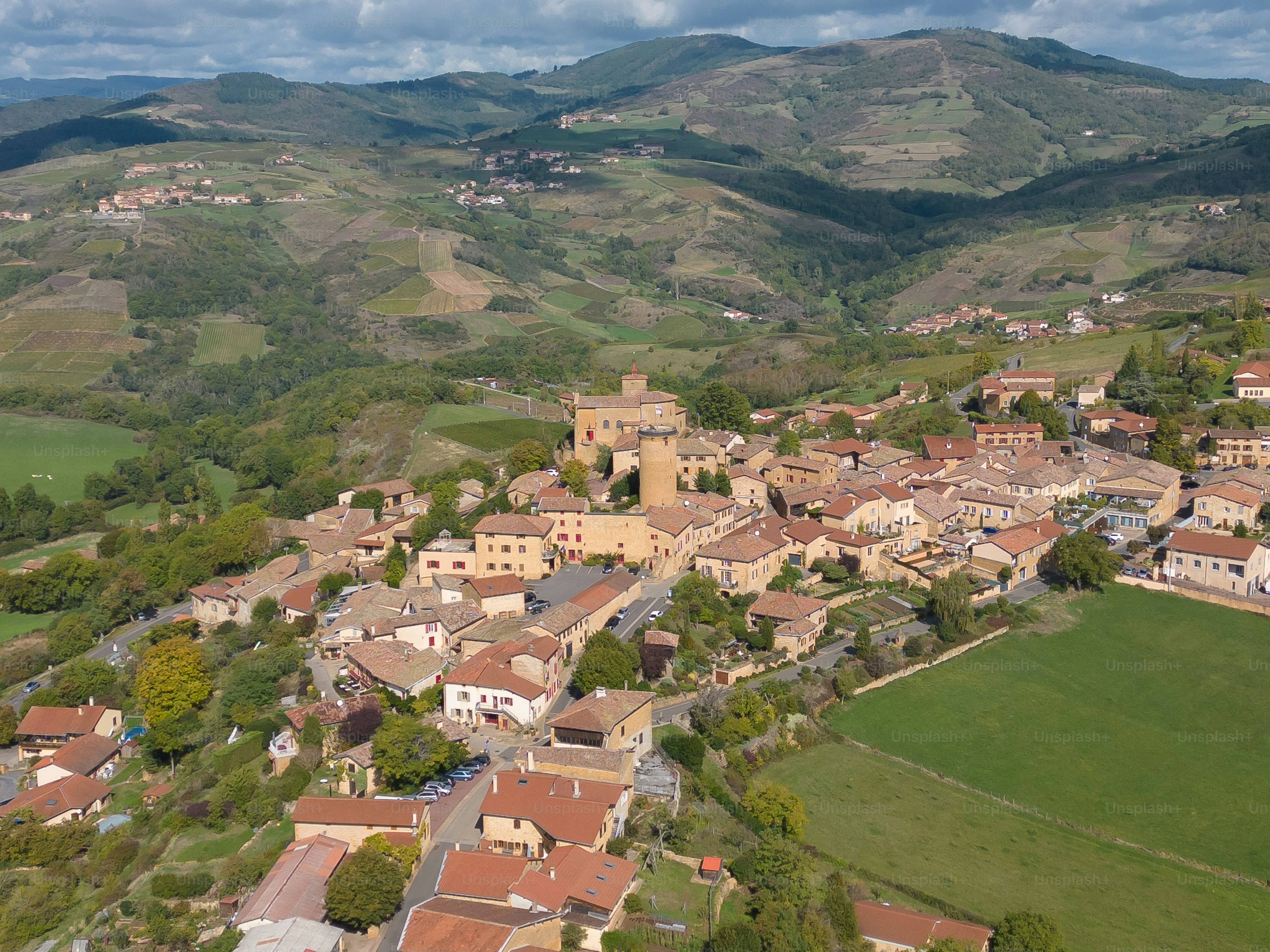 Aerial drone view of the French village of Oingt, in the Beaujolais region of eastern France, famous for its vineyards & wineries. The medieval village is located northwest of Lyon and is often listed as one of the prettiest villages in France.