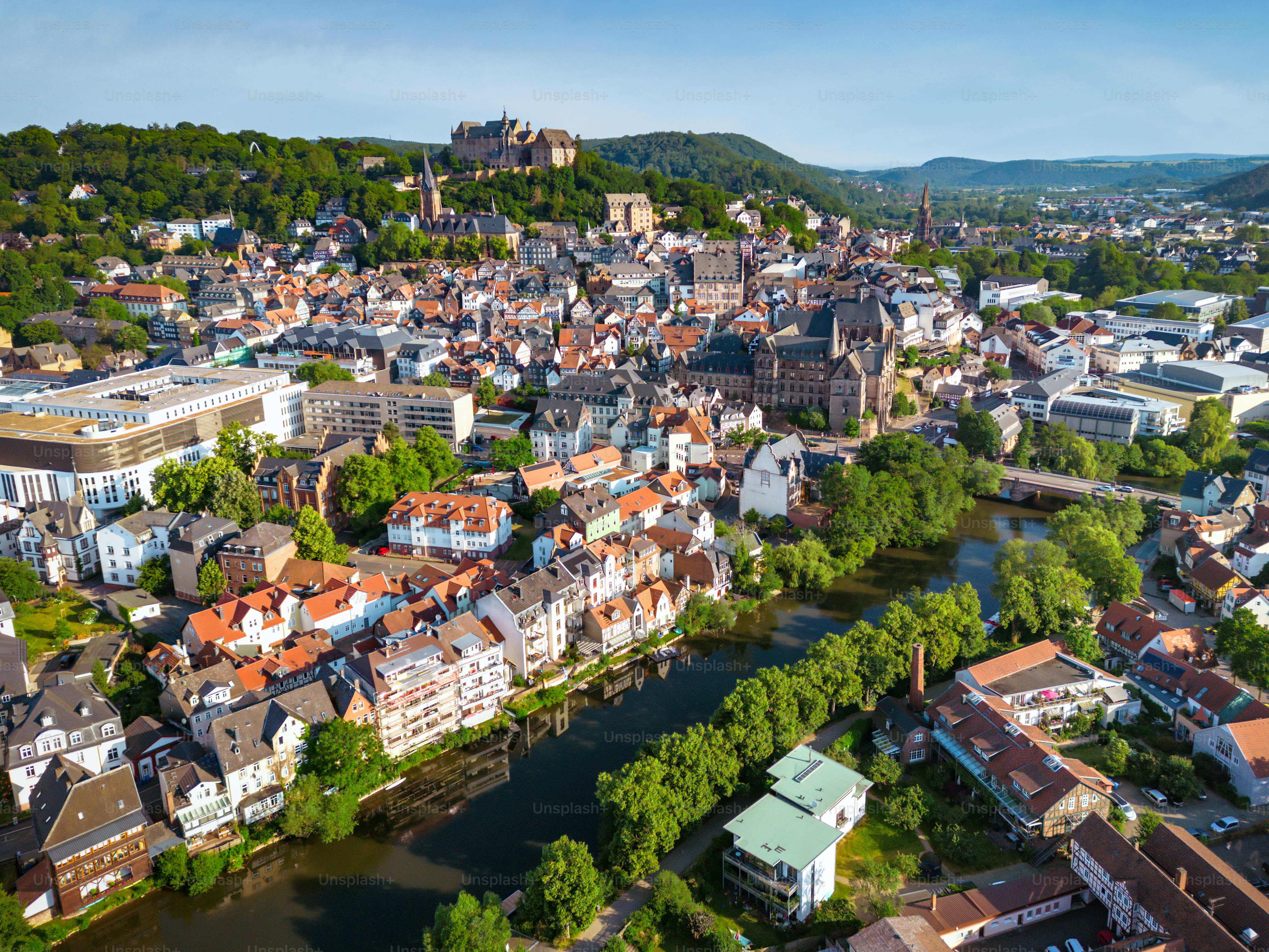 drone view on historic Marburg over Lahn river at blue summer morning