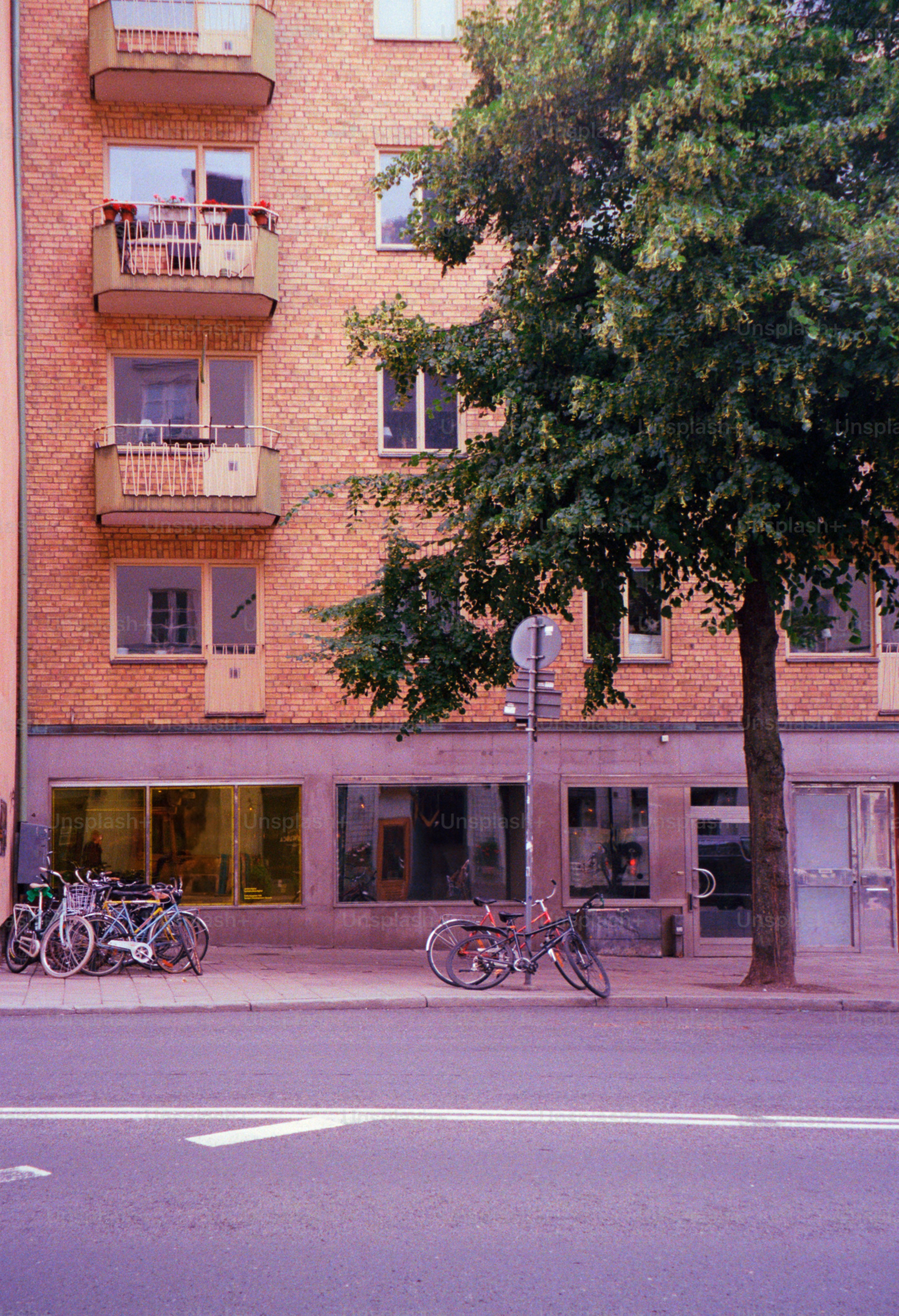 Apartment building with bicycles parked out front.