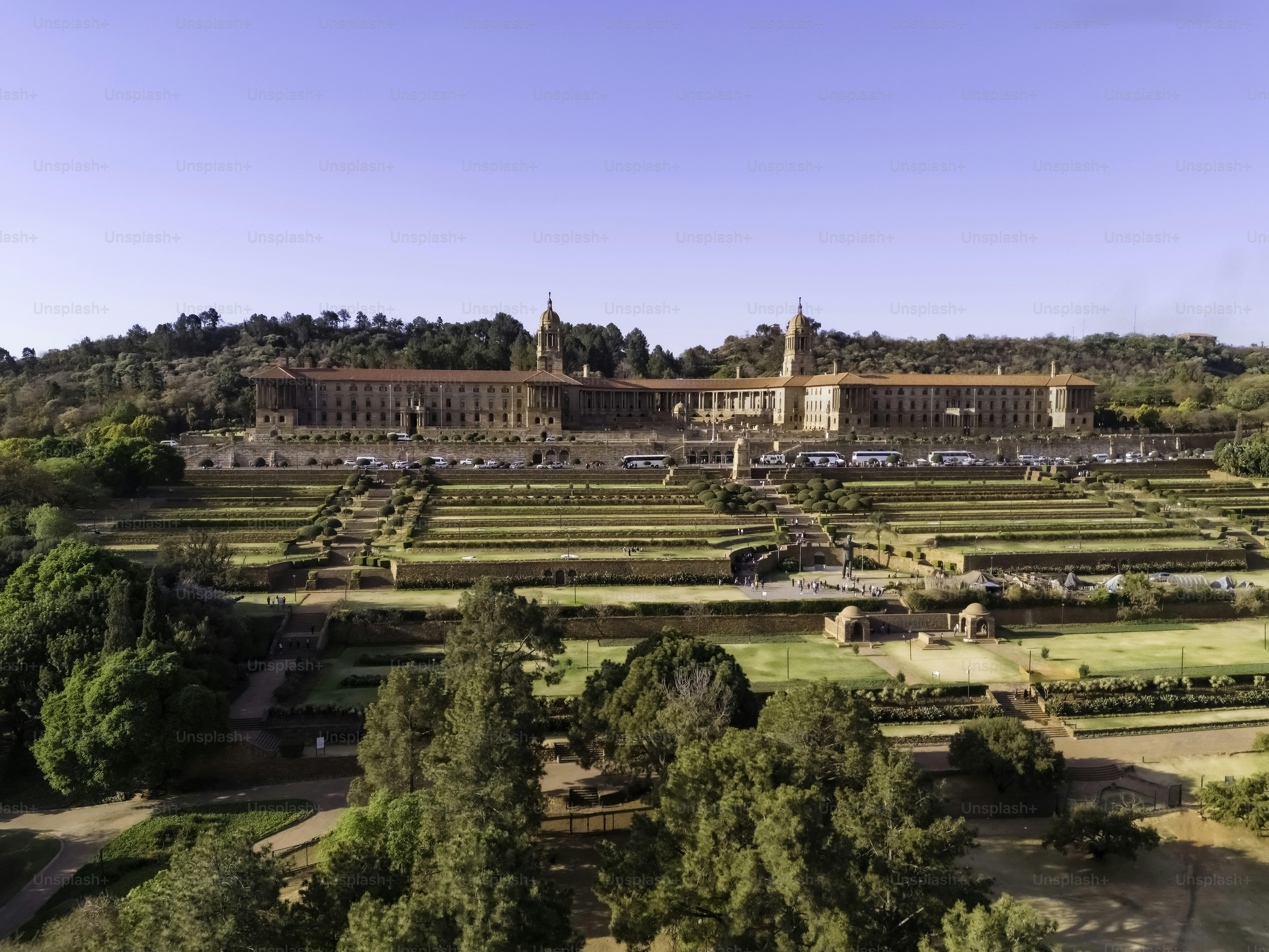 The Union Buildings is the official seat of the south african government seen here with the landscaped gardens featuring Nelson Mandela statue, declared a National Heritage site and now an UNESCO World Heritage site, in Pretoria / Tshwane.