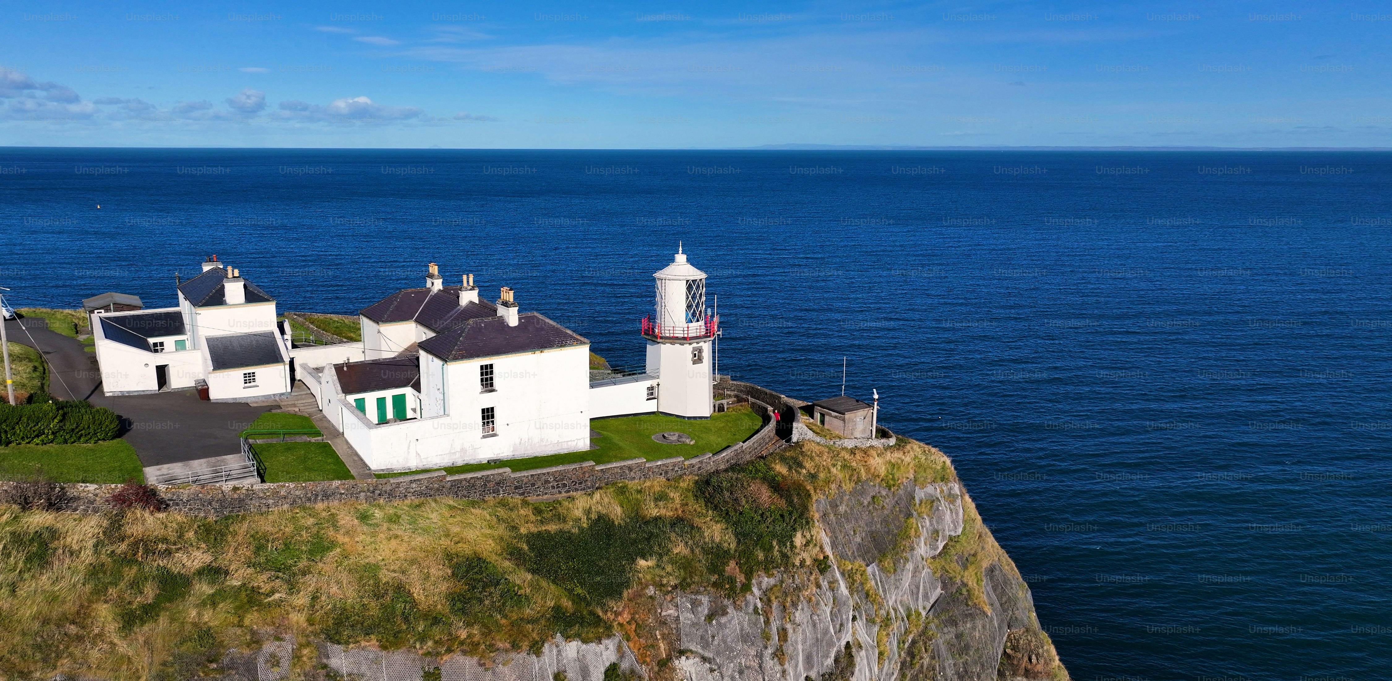Panoramic Aerial view of Blackhead Lighthouse on the beautiful and spectacular coastline of the Glens of Antrim Northern Ireland