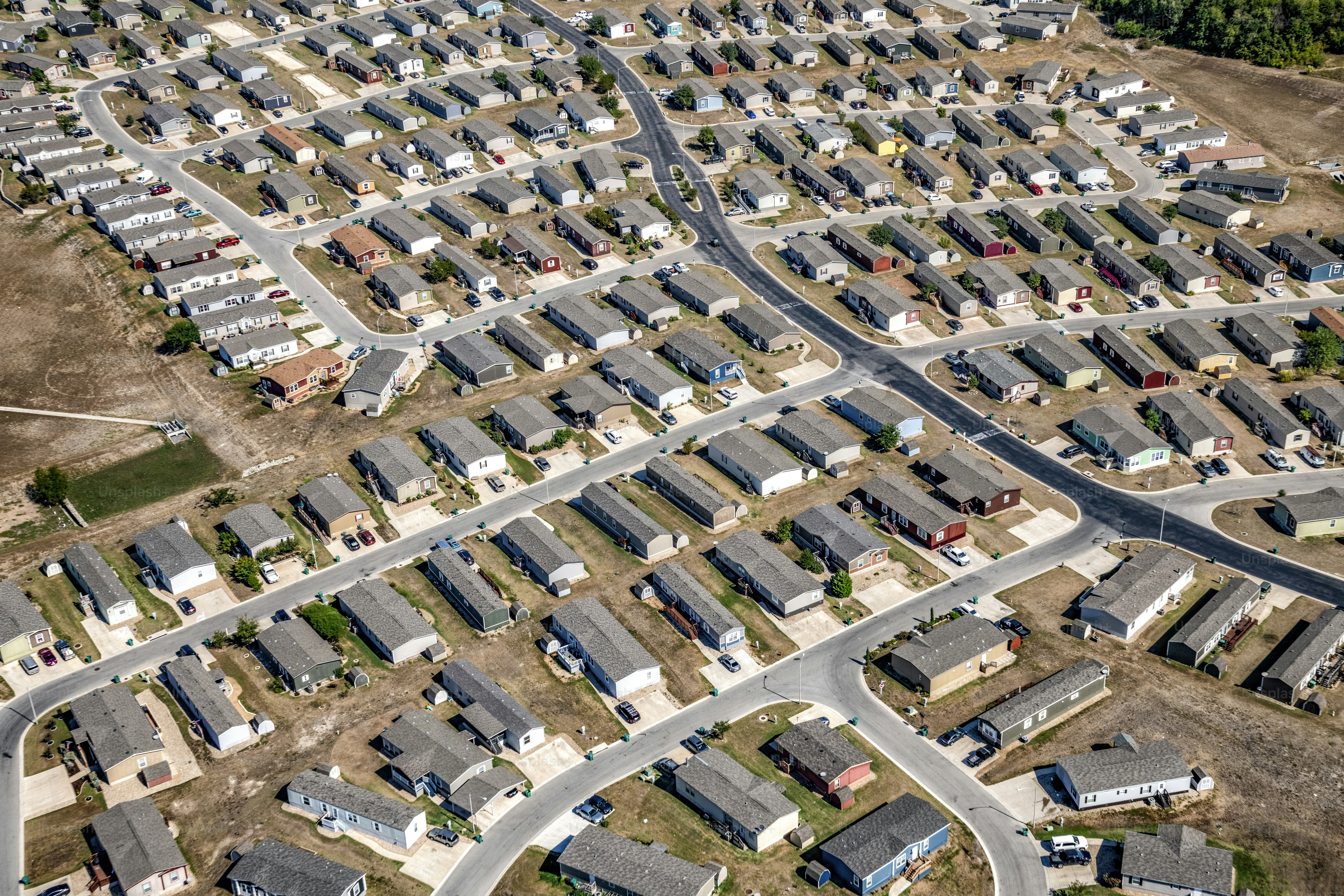 A large master planned, suburban residential community consisting of manufactured homes located north of downtown Austin, Texas in the town of Pflugerville shot from an altitude of about 1200 feet on a clear sunny morning.