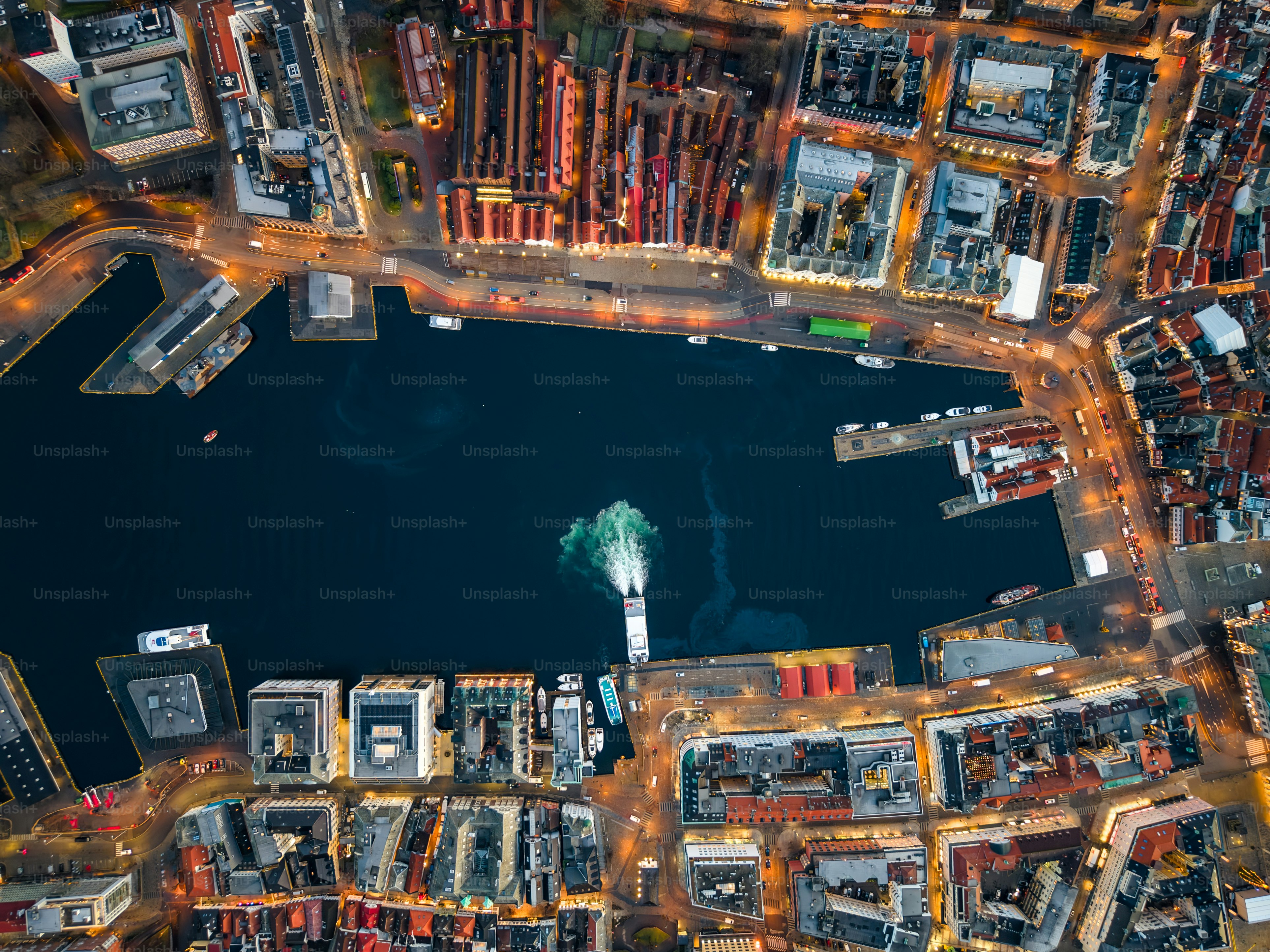 Night aerial of historic wooden Hanseatic fjord town Bergen, Norway