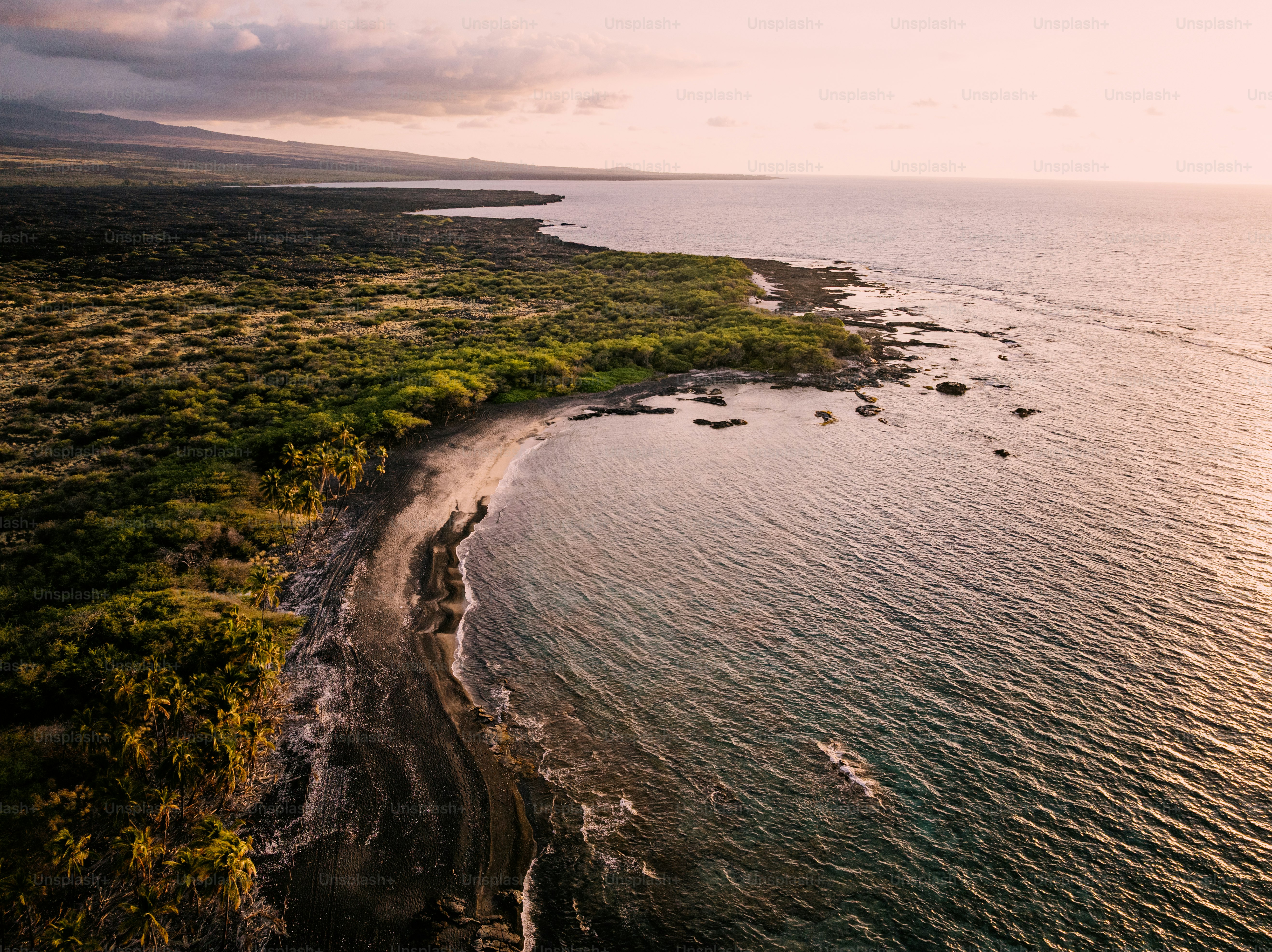 Aerial views along the peaceful coastline of the west side of Big Island of the Pacific Hawaiian islands at dusk.