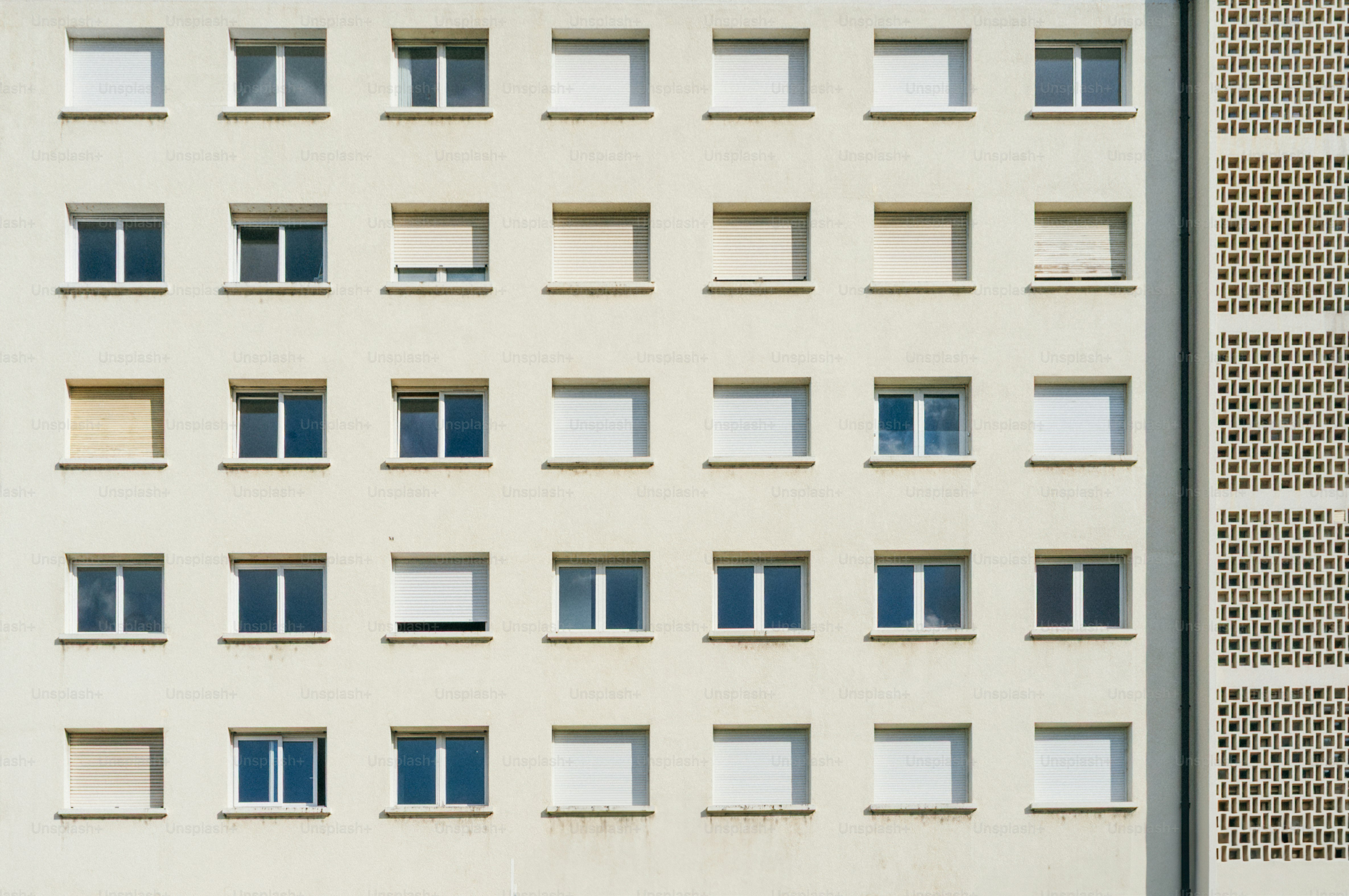 Building facade with numerous windows in rows.