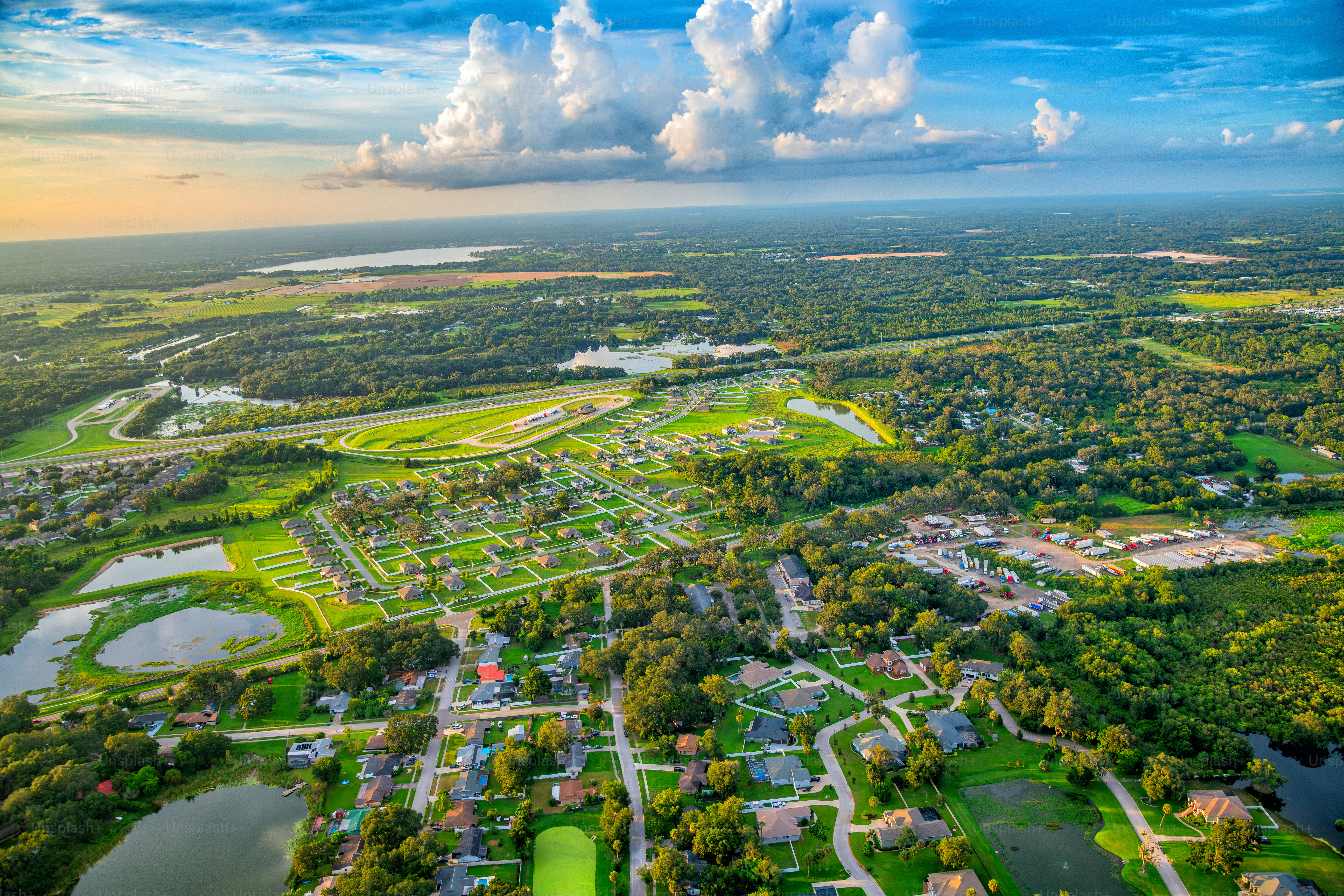 Wide angle aerial view of a suburban subdivision and the surrounding land located near Lakeland east of downtown Tampa, Florida shot via helicopter from an altitude of about 1500 feet.