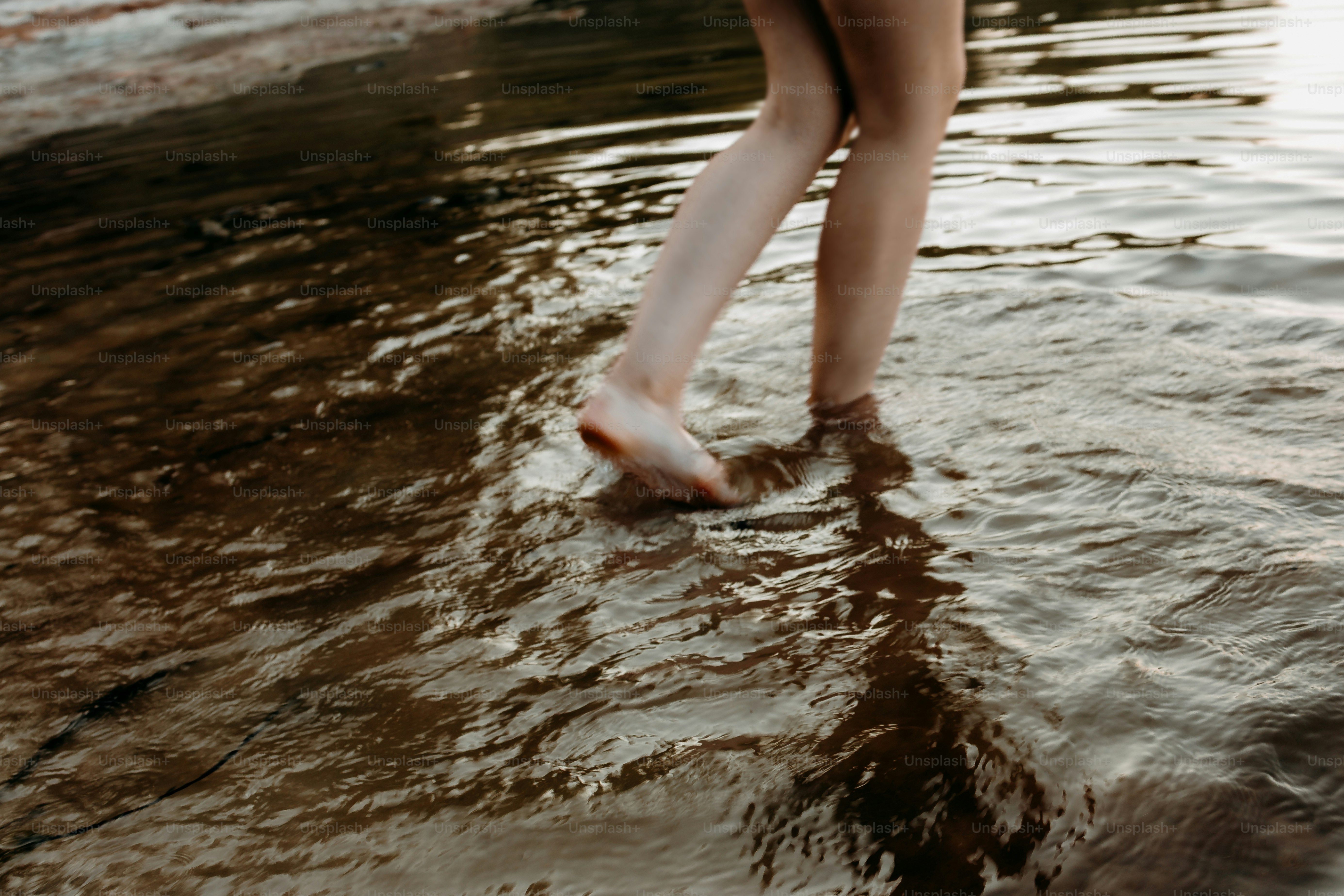 Bare feet wade through the water