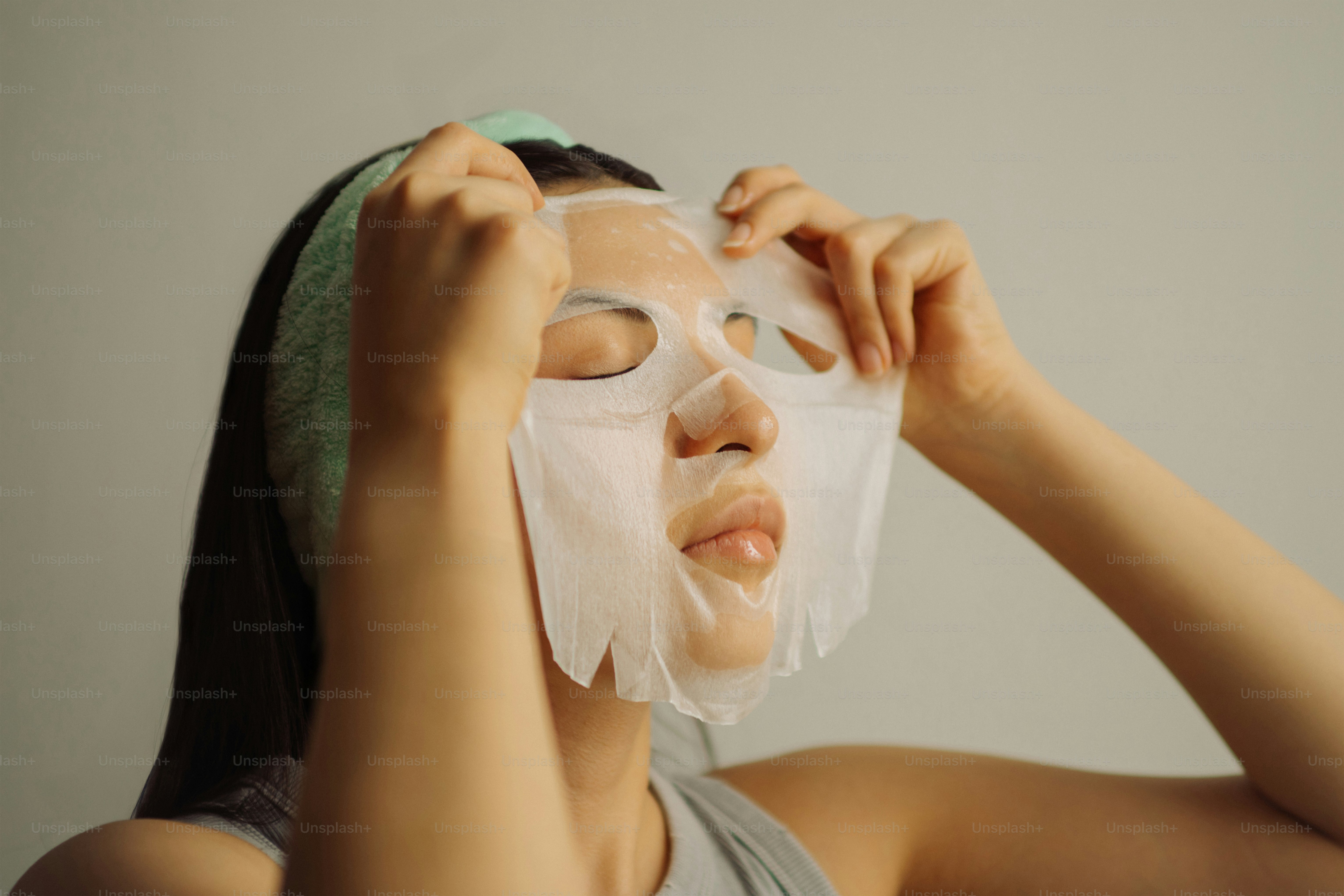 Woman is smiling while removing a facial mask. photo – Beauty Image on ...
