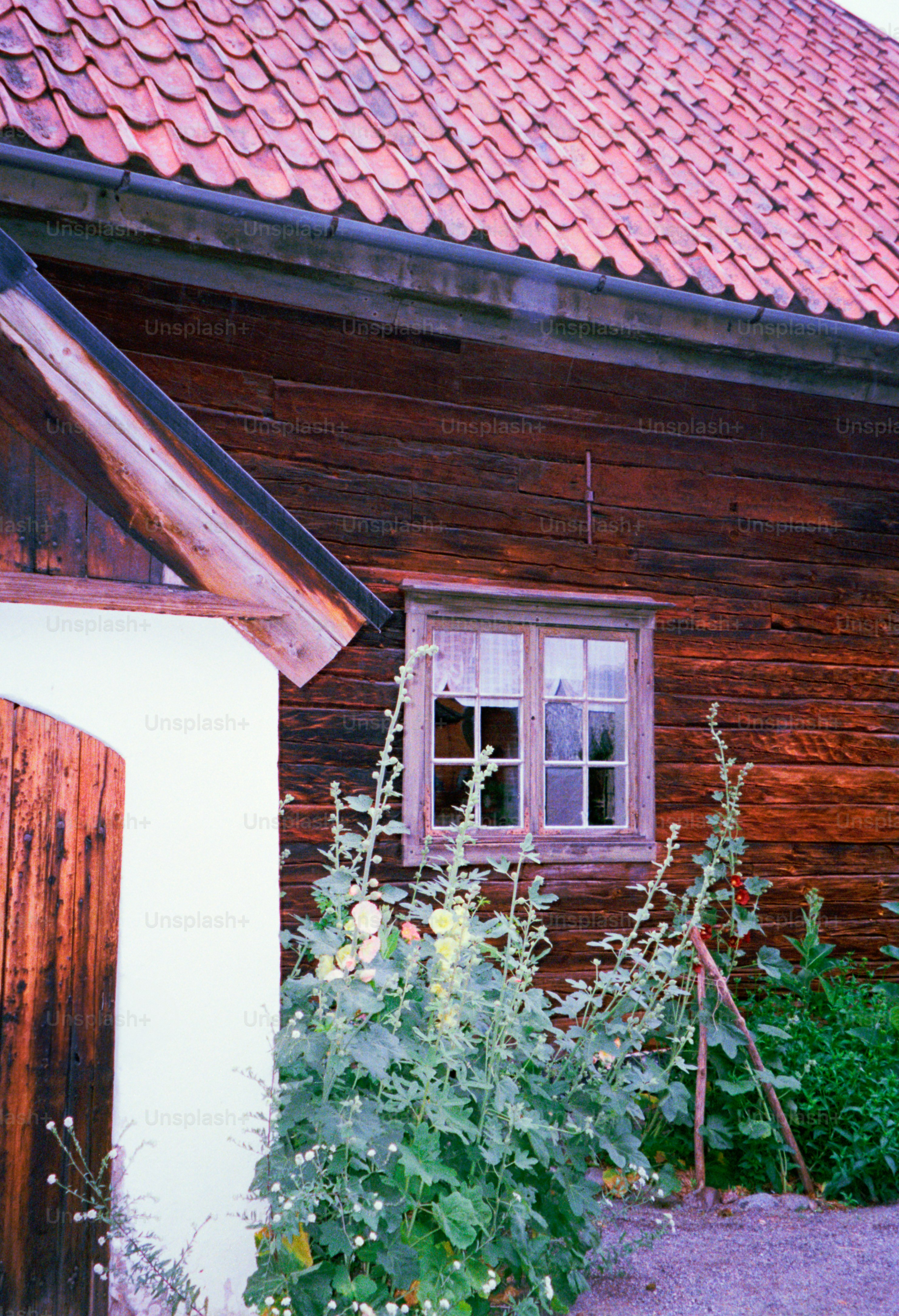 A wooden building with a red tile roof.