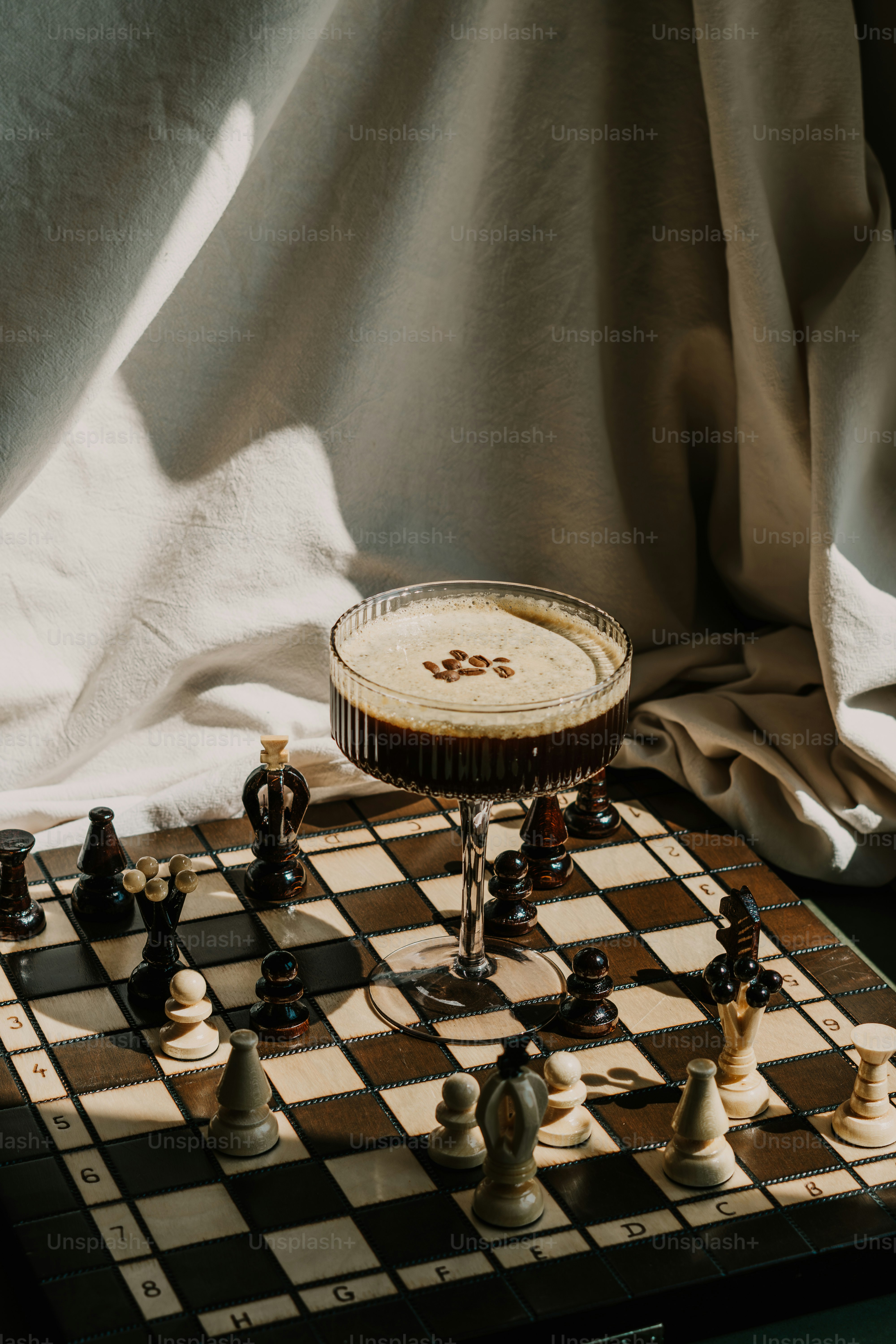 A cocktail sits on a chessboard.